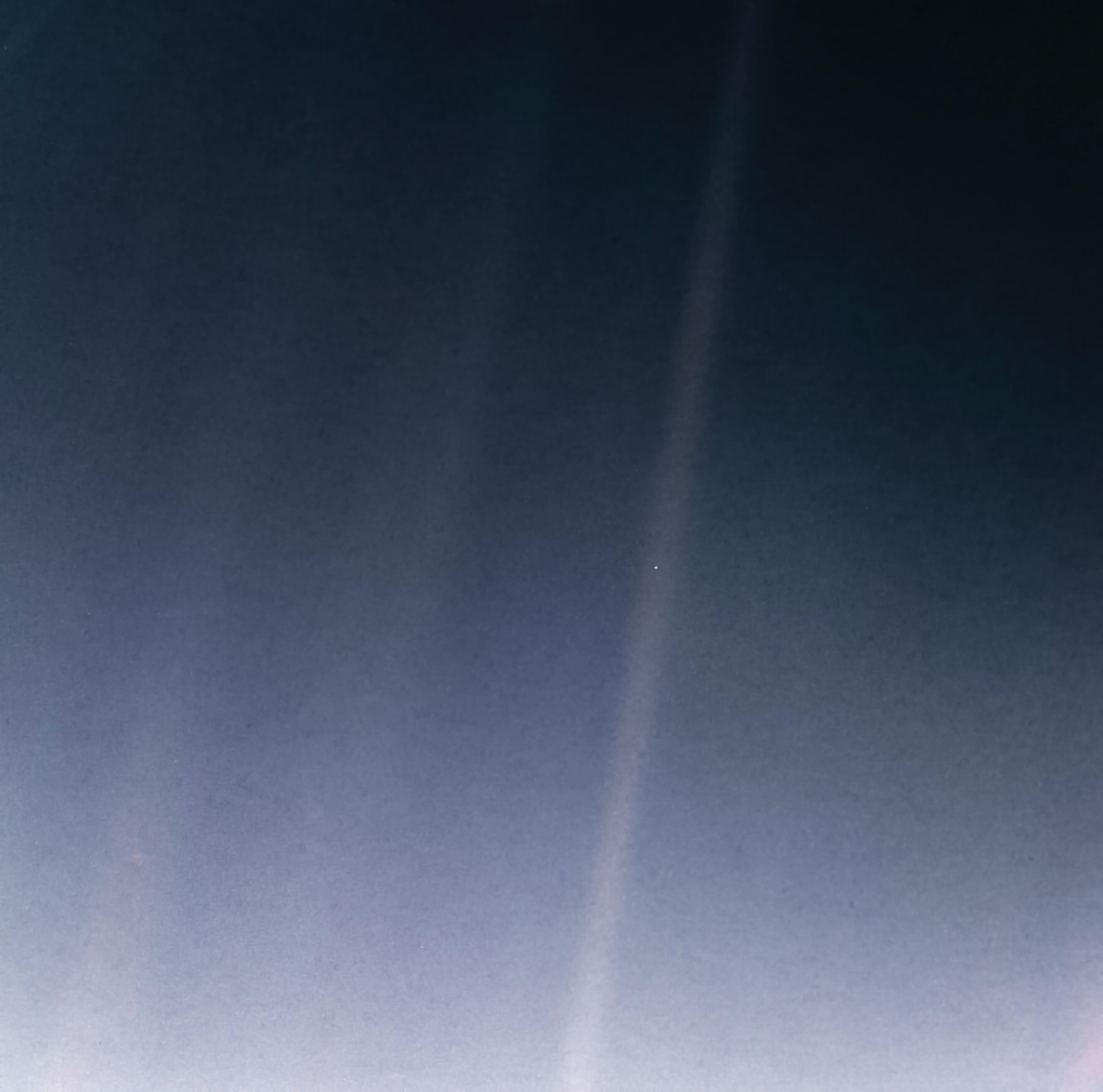 On Valentine's Day in 1990, cruising four billion miles from the Sun, the Voyager 1 spacecraft looked back one last time to make the first ever Solar System family portrait. The portrait consists of the Sun and six planets in a 60 frame mosaic made from a vantage point 32 degrees above the ecliptic plane. Planet Earth was captured within a single pixel in this single frame. It's the pale blue dot within the sunbeam just right of center in this reprocessed version of the now famous view from Voyager. Astronomer Carl Sagan originated the idea of using Voyager's camera to look back toward home from a distant perspective. Thirty years later, on this Valentine's day, look again at the pale blue dot.