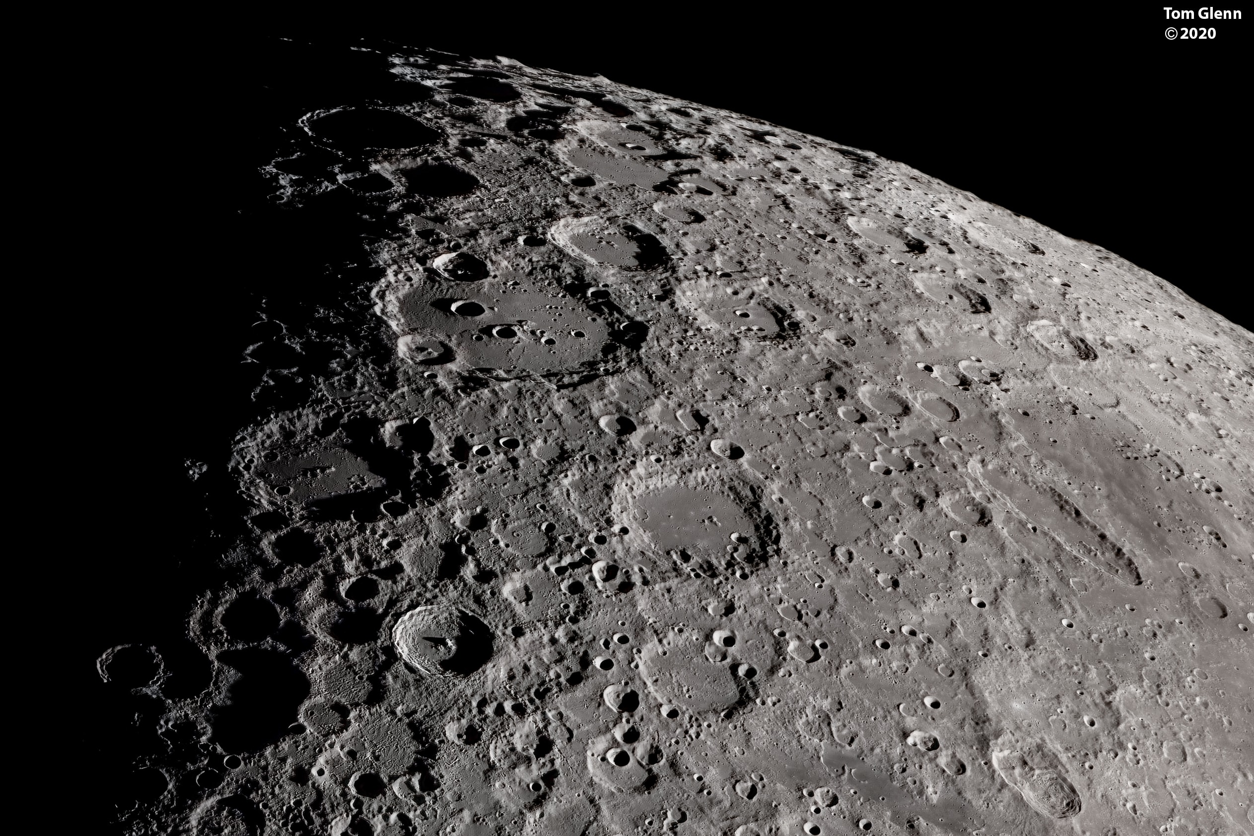 The Moon's south pole is near the top of this detailed telescopic view. Looking across the rugged southern lunar highlands it was captured from southern California, planet Earth. At the Moon's third quarter phase the lunar terminator, the sunset shadow line, is approaching from the left. The scene's foreshortened perspective heightens the impression of a dense field of craters and makes the craters themselves appear more oval shaped close to the lunar limb. Below and left of center is sharp-walled crater Tycho, 85 kilometers in diameter. Young Tycho's central peak is still in sunlight, but casts a long shadow across the crater floor. The large prominent crater to the south (above) Tycho is Clavius. Nearly 231 kilometers in diameter its walls and floor are pocked with smaller, more recent, overlaying impact craters. Mountains visible along the lunar limb at the top can rise about 6 kilometers or so above the surrounding terrain.