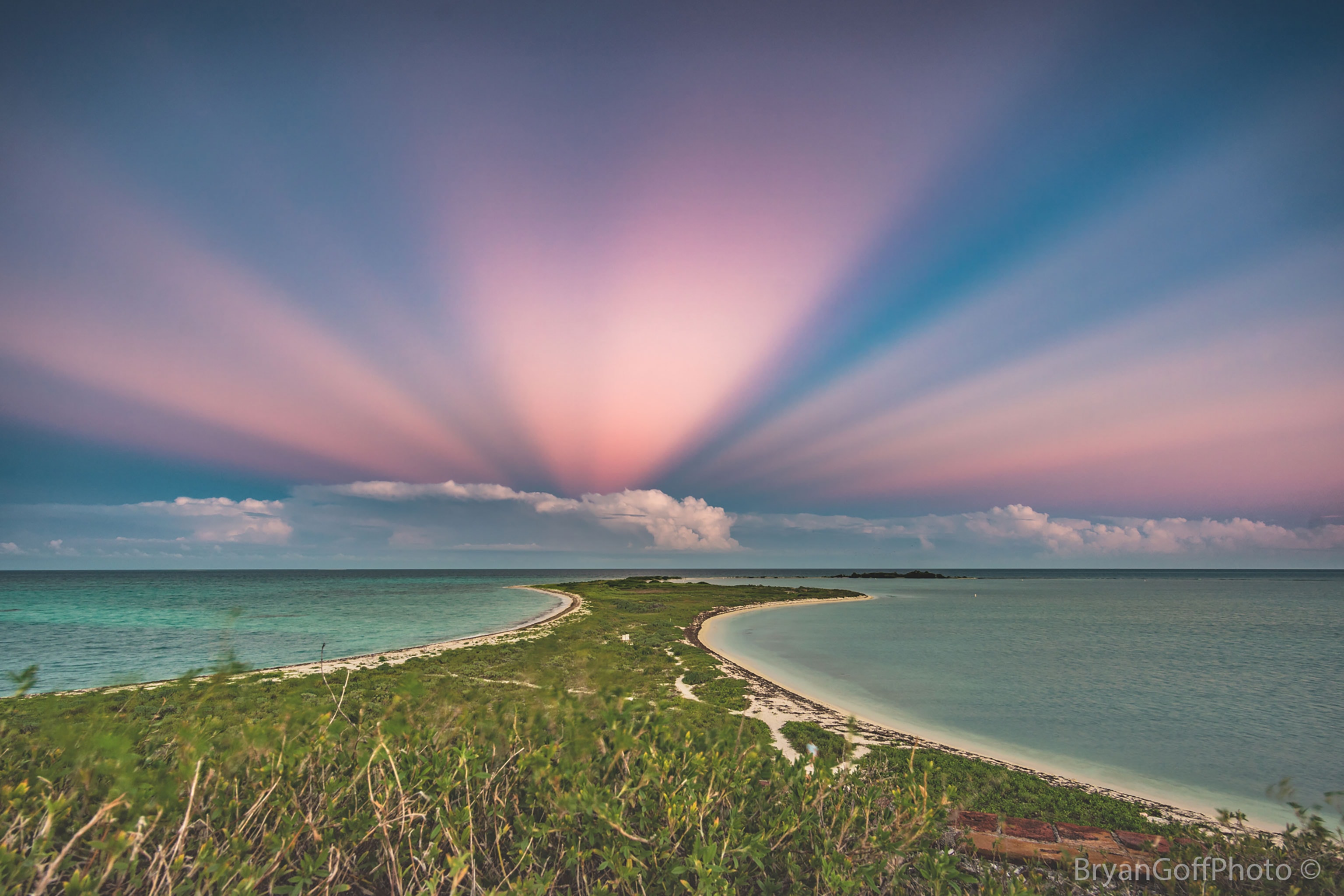 What's happening behind those clouds?  Although the scene may appear somehow supernatural, nothing more unusual is occurring than a Sun setting on the other side of the sky.  Pictured here are anticrepuscular rays.  To understand them, start by picturing common crepuscular rays that are seen any time that sunlight pours though scattered clouds. Now although sunlight indeed travels along straight lines, the projections of these lines onto the spherical sky are great circles.  Therefore, the crepuscular rays from a setting (or rising) sun will appear to re-converge on the other side of the sky.  At the anti-solar point 180 degrees around from the Sun, they are referred to as anticrepuscular rays.  Featured here is a particularly striking display of anticrepuscular rays photographed in 2016 over Dry Tortugas National Park in Florida, USA.