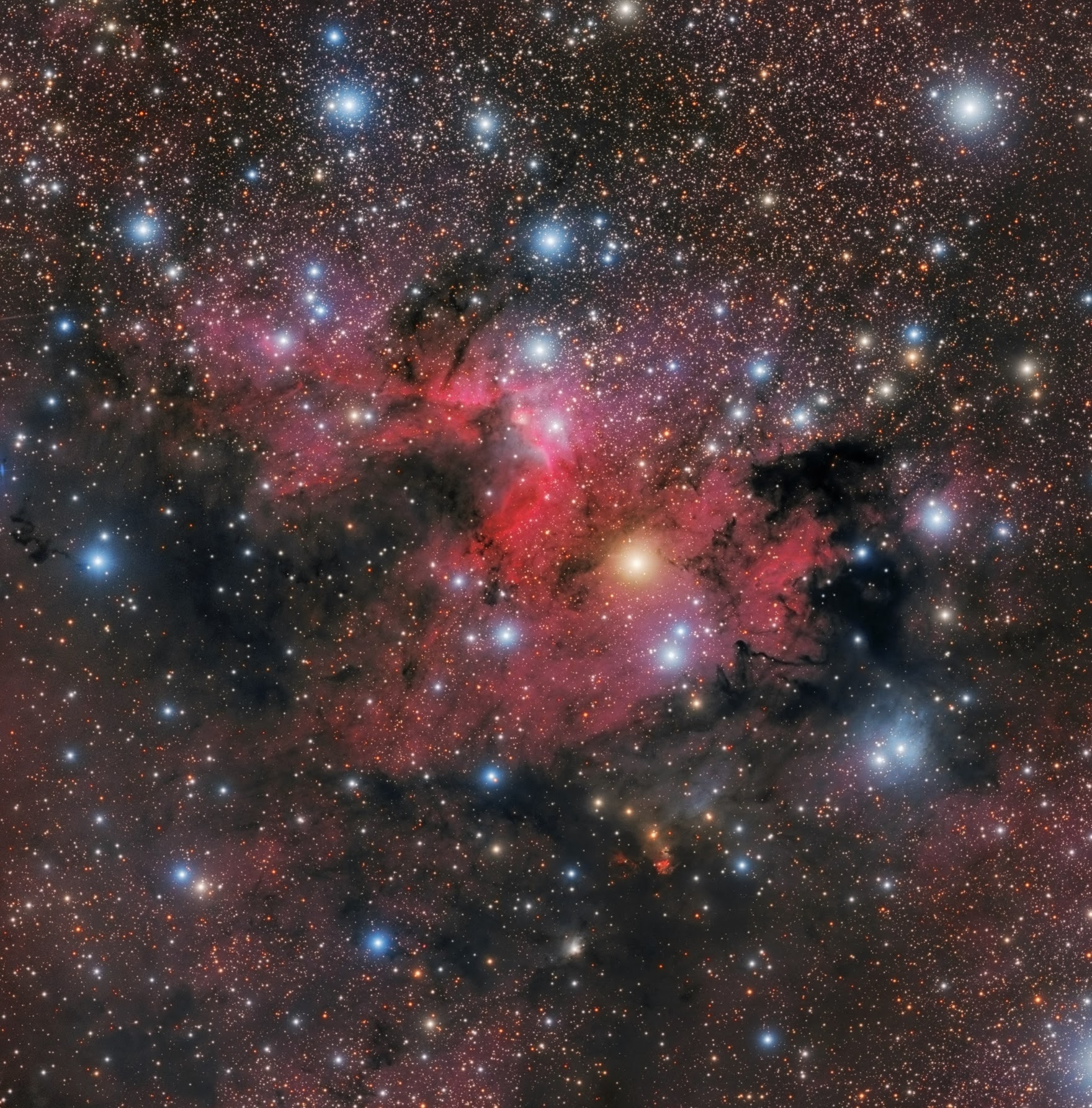 This colorful skyscape spans about four full moons across nebula rich starfields along the plane of our Milky Way Galaxy in the royal northern constellation Cepheus. Near the edge of the region's massive molecular cloud some 2,400 light-years away, bright reddish emission region Sharpless (Sh) 155 is left of center, also known as the Cave Nebula. About 10 light-years across the cosmic cave's bright walls of gas are ionized by ultraviolet light from the hot young stars around it. Dusty blue reflection nebulae, like vdB 155 at lower right, and dense obscuring clouds of dust also abound on the interstellar canvas. Astronomical explorations have revealed other dramatic signs of star formation, including the bright red fleck of Herbig-Haro (HH) 168. Below center in the frame, the Herbig-Haro object emission is generated by energetic jets from a newborn star.