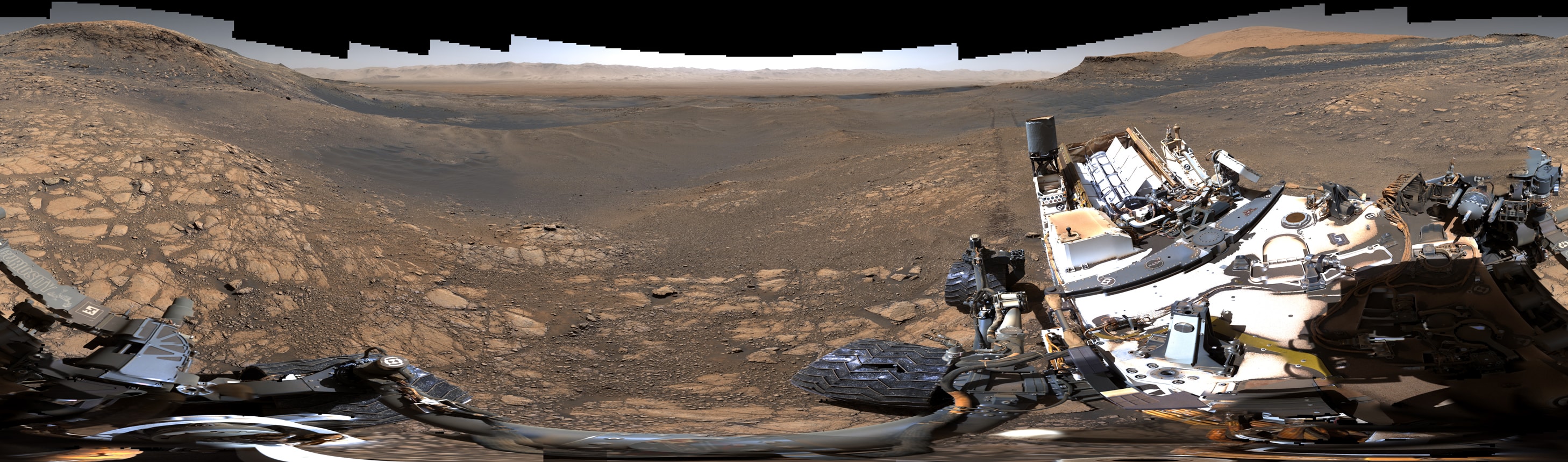 The Mars Rover named Curiosity recorded high-resolution, 360 degree views of its location on Mars late last year. The panoramic scene was stitched from over 1,000 images from Curiosity's Mast camera or Mastcam. In this version, captured with Mastcam's medium angle lens, the rover's deck and robotic arm are in the foreground, stretched and distorted by the extreme wide perspective. Just beyond the rover are regions of clay rich rock, evidence for an ancient watery environment, with a clear view toward more distant martian ridges and buttes. Gale crater wall runs across the center (toward the north) in the background over 30 kilometers in the distance. The upper reaches of Mt. Sharp are at the far right. Images to construct the panorama were recorded over 4 consecutive sols between local noon and 2pm to provide consistent lighting. Zoom in to the panoramic scene and you can easily spot the shadow casting sundial mounted on rover's deck (right). In July NASA plans to launch a new rover to Mars named Perseverance.