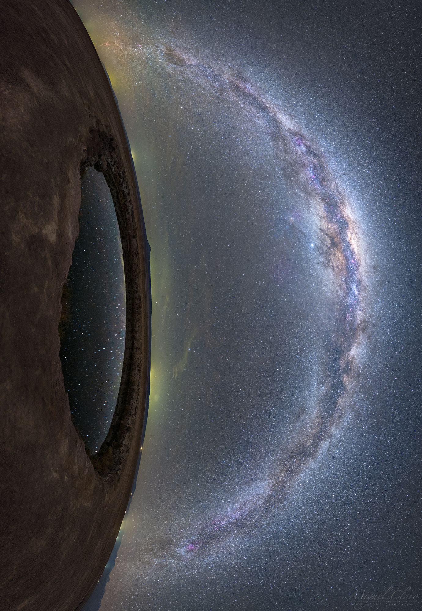 Have you ever had stars in your eyes? It appears that the eye on the left does, and moreover it appears to be gazing at even more stars. The featured 27-frame mosaic was taken last July from Ojas de Salar in the Atacama Desert of Chile.  The eye is actually a small lagoon captured reflecting the dark night sky as the Milky Way Galaxy arched overhead. The seemingly smooth band of the Milky Way is really composed of billions of stars, but decorated with filaments of light-absorbing dust and red-glowing nebulas. Additionally, both Jupiter (slightly left the galactic arch) and Saturn (slightly to the right) are visible.  The lights of small towns dot the unusual vertical horizon.  The rocky terrain around the lagoon appears to some more like the surface of Mars than our Earth.