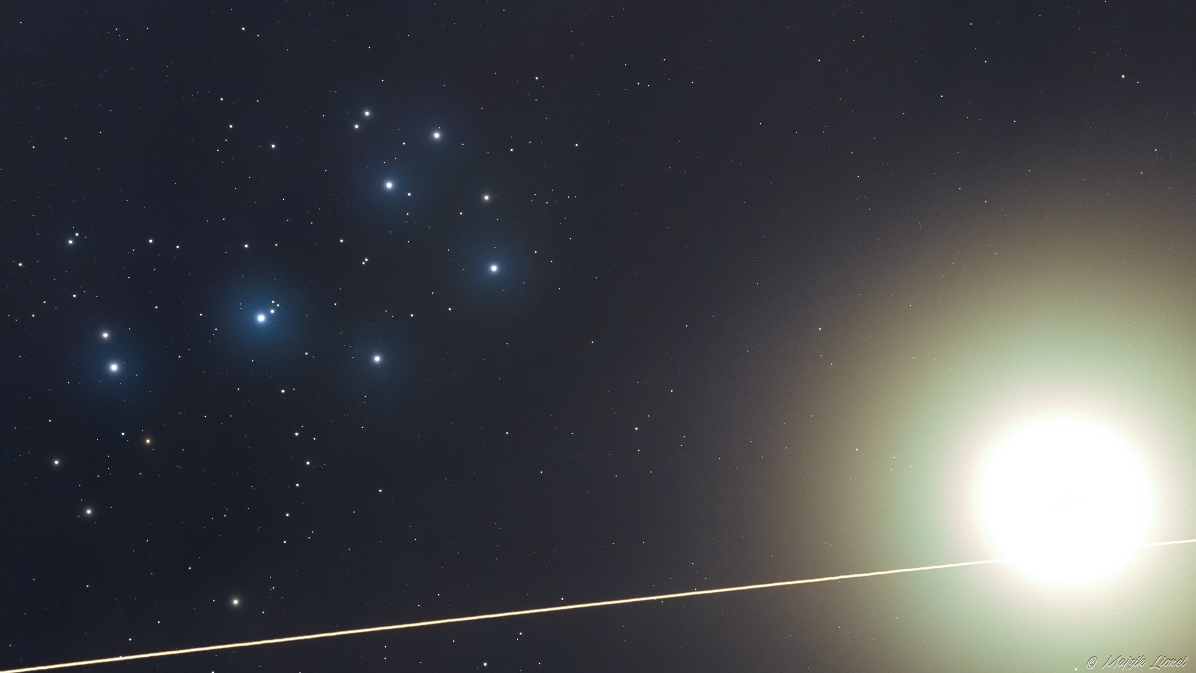 There's a traffic jam in Taurus lately. On April 1, this celestial frame from slightly hazy skies over Tapiobicske, Hungary recorded an impressive pile up toward the zodiacal constellation of the Bull and the Solar System's ecliptic plane. Streaking right to left the International Space Station speeds across the bottom of the telescopic field of view. Wandering about as far from the Sun in planet Earth's skies as it can get, inner planet Venus is bright and approaching much slower, overexposed at the right. Bystanding at the upper left are the sister stars of the Pleiades. No one has been injured in the close encounter though, because it really isn't very close. Continuously occupied since November 2000, the space station orbits some 400 kilometers above the planet's surface. Venus, currently the brilliant evening star, is almost 2/3 of an astronomical unit away. A more permanent resident of Taurus, the Pleiades star cluster is 400 light-years distant.