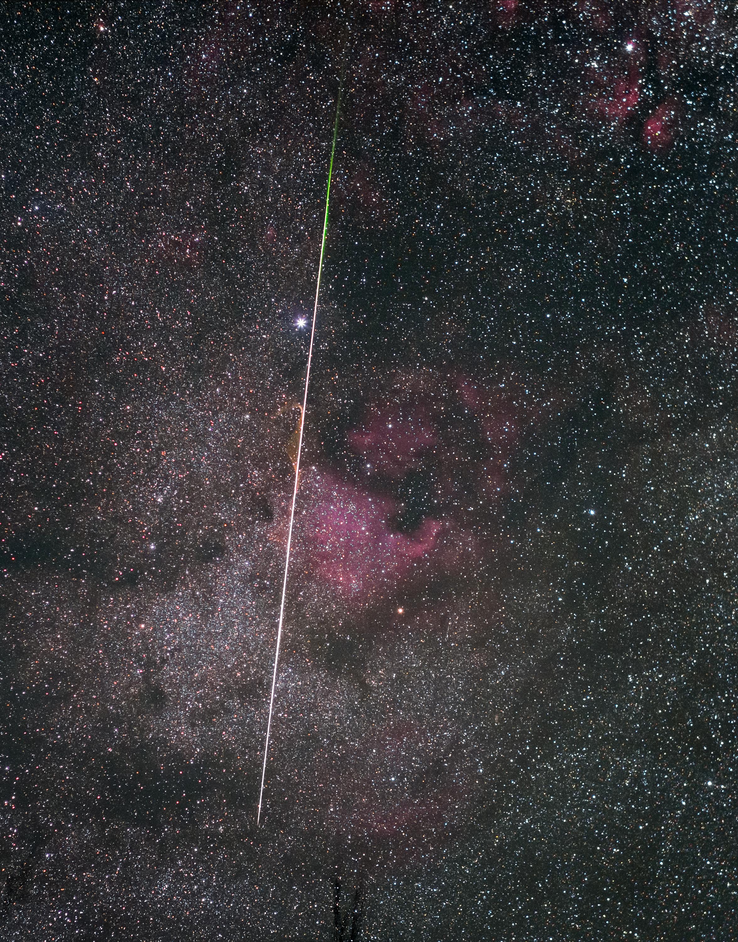 rth's annual Lyrid Meteor Shower peaked before dawn yesterday, as our fair planet plowed through debris from the tail of long-period comet Thatcher. In crisp, clear and moonless predawn skies over Brown County, Indiana this streak of vaporizing comet dust briefly shared a telephoto field of view with stars and nebulae along the Milky Way. Alpha star of the constellation Cygnus, Deneb lies near the bright meteor's path along with the region's dark interstellar clouds of dust and the recognizable glow of the North America nebula (NGC 7000). The meteor's streak points back to the shower's radiant, its apparent point of origin on the sky. That would be in the constellation Lyra, near bright star Vega and off the top edge of the frame.   Celebrate the Night: International Dark Sky Week