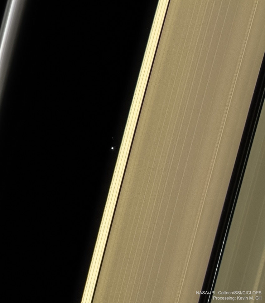 What are those dots between Saturn's rings? Our Earth and Moon. Just over three years ago, because the Sun was temporarily blocked by the body of Saturn, the robotic Cassini spacecraft was able to look toward the inner Solar System. There, it spotted our Earth and Moon -- just pin-pricks of light lying about 1.4 billion kilometers distant. Toward the right of the featured image is Saturn's A ring, with the broad Encke Gap on the far right and the narrower Keeler Gap toward the center.  On the far left is Saturn's continually changing F Ring.  From this perspective, the light seen from Saturn's rings was scattered mostly forward , and so appeared backlit.  After more than a decade of exploration and discovery, the Cassini spacecraft ran low on fuel in 2017 and was directed to enter Saturn's atmosphere, where it surely melted.   Gallery: Notable Venus & Mercury Conjunction 2020 Images submitted to APOD