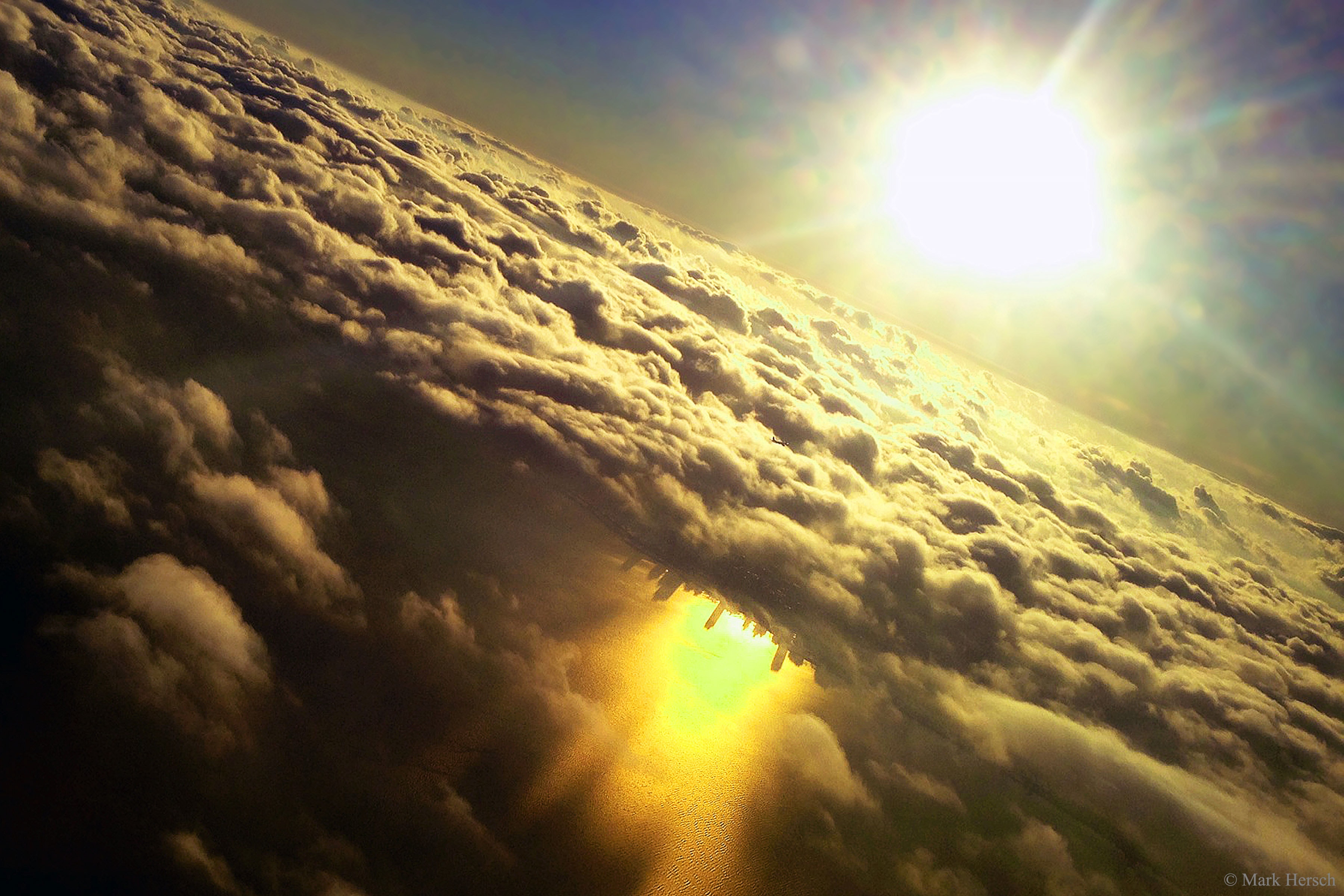 How could that city be upside-down? The city, Chicago, was actually perfectly right-side up. The long shadows it projected onto nearby Lake Michigan near sunset, however, when seen in reflection, made the buildings appear inverted. This fascinating, puzzling, yet beautiful image was captured by a photographer in 2014 on an airplane on approach to Chicago's O'Hare International Airport.  The Sun can be seen both above and below the cloud deck, with the latter reflected in the calm lake.  As a bonus, if you look really closely -- and this is quite a challenge -- you can find another airplane in the image, likely also on approach to the same airport.