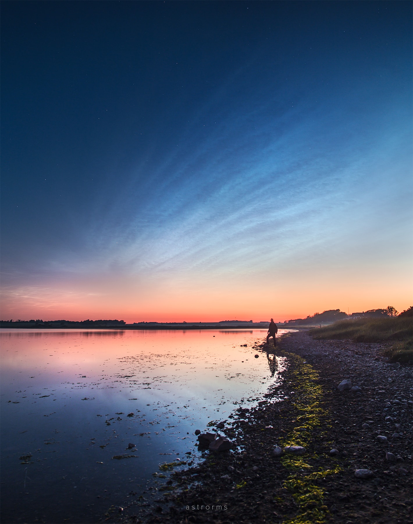Transfusing sunlight through a darkened sky, this beautiful display of noctilucent clouds was captured earlier this week, reflected in calm waters from Nykobing Mors, Denmark. From the edge of space, about 80 kilometers above Earth's surface, the icy clouds themselves still reflect sunlight, though the Sun is below the horizon as seen from the ground. Usually spotted at high latitudes in summer months the night shining clouds have made an early appearance this year as northern nights grow short. Also known as polar mesopheric clouds they are understood to form as water vapor driven into the cold upper atmosphere condenses on the fine dust particles supplied by disintegrating meteors or volcanic ash. NASA's AIM mission provides daily projections of noctilucent clouds as seen from space.