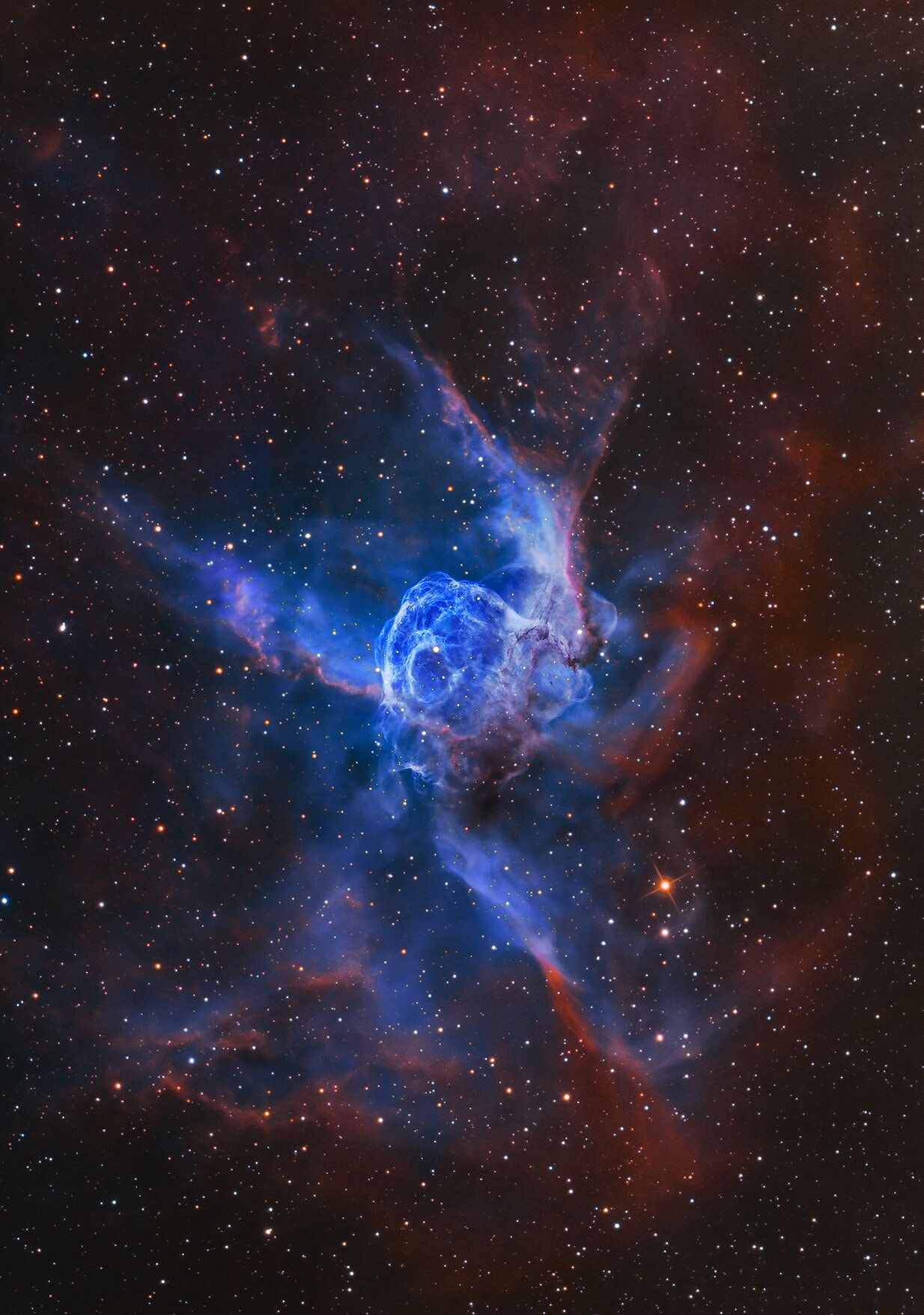 NGC 2359 is a helmet-shaped cosmic cloud with wing-like appendages popularly called Thor's Helmet. Heroically sized even for a Norse god, Thor's Helmet is about 30 light-years across. In fact, the helmet is more like an interstellar bubble, blown as a fast wind from the bright, massive star near the bubble's center inflates a region within the surrounding molecular cloud. Known as a Wolf-Rayet star, the central star is an extremely hot giant thought to be in a brief, pre-supernova stage of evolution. NGC 2359 is located about 15,000 light-years away in the constellation of the Great Overdog. The remarkably sharp image is a mixed cocktail of data from broadband and narrowband filters using three different telescopes. It captures natural looking stars and the details of the nebula's filamentary structures. The predominant bluish hue is strong emission from doubly ionized oxygen atoms in the glowing gas.