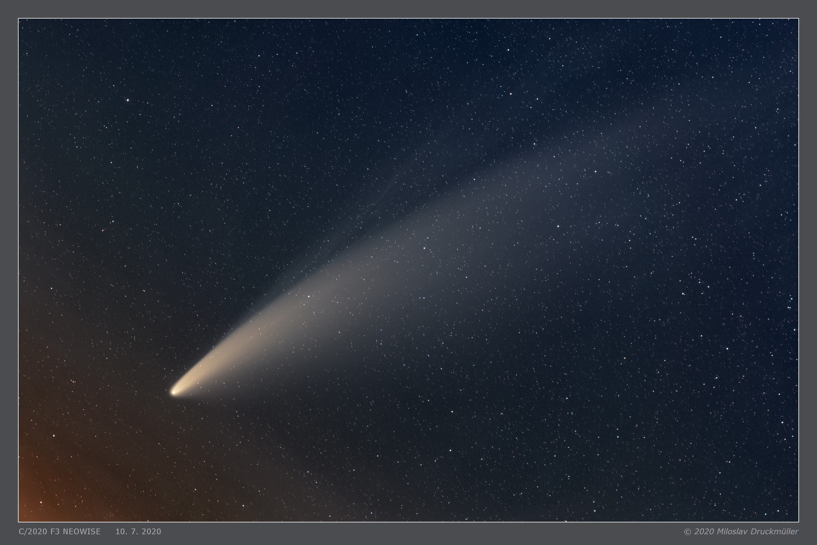 Comet NEOWISE (C/2020 F3) is now sweeping through northern skies. Its developing tails stretch some six degrees across this telescopic field of view, recorded from Brno, Czech Republic before daybreak on July 10. Pushed out by the pressure of sunlight itself, the comet's broad, yellowish dust tail is easiest to see. But the image also captures a fainter, more bluish tail too, separate from the reflective comet dust. The fainter tail is an ion tail, formed as ions from the cometary coma are dragged outward by magnetic fields in the solar wind and fluoresce in the sunlight. In this sharp portrait of our new visitor from the outer Solar System, the tails of comet NEOWISE are reminiscent of the even brighter tails of Hale Bopp, the Great Comet of 1997.   Comet NEOWISE from Around the Globe: Notable Images Submitted to APOD