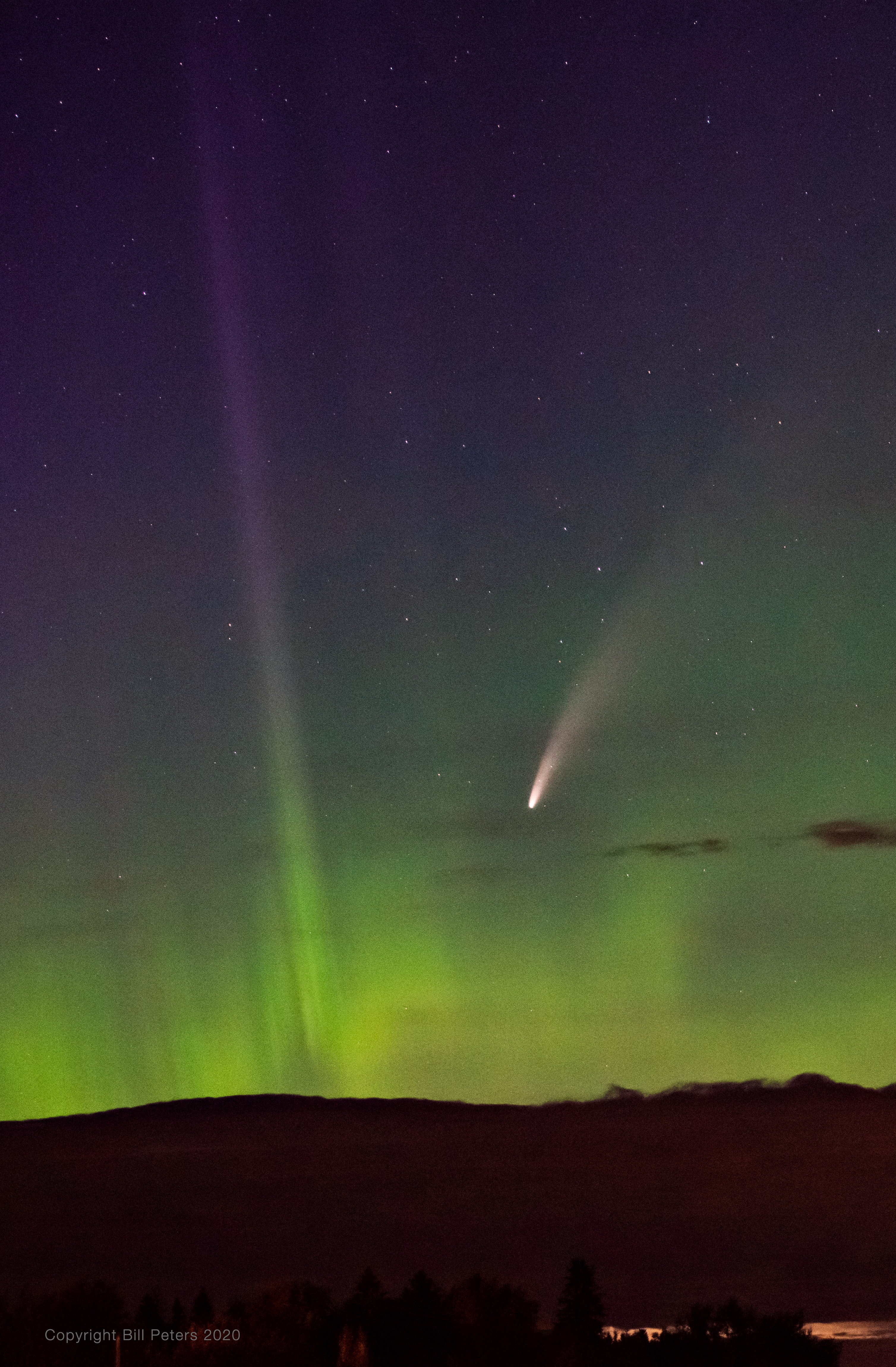 After local midnight on July 14 comet NEOWISE was still above the horizon for Goldenrod, Alberta, Canada, just north of Calgary, planet Earth. In this snapshot it makes for an awesome night with dancing displays of the northern lights. The long-tailed comet and auroral displays are beautiful apparitions in the north these days. Both show the influence of spaceweather and the wind from the Sun. Skygazers have widely welcomed the visitor from the Oort cloud, though C/2020 F3 (NEOWISE) is in an orbit that is now taking it out of the inner Solar System.  Comet NEOWISE Images: July 16 | July 15 | July 14 | July 13 | July 12 | July 11 | July 10 & earlier