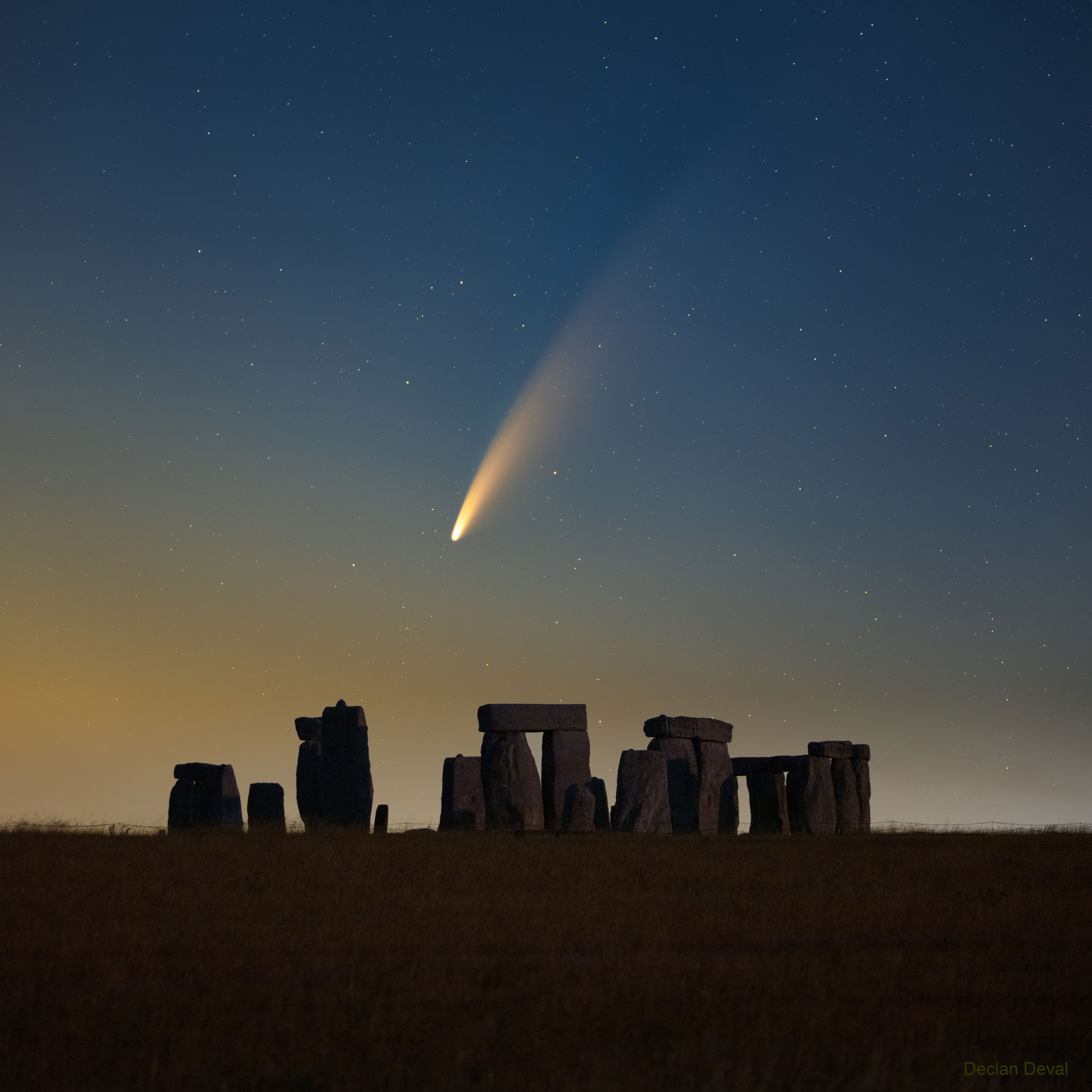 Have you ever seen a comet? Tonight -- and likely the next few nights -- should be a good chance. Go outside just at sunset and look to your northwest.  The lower your horizon, the better.  Binoculars may help, but if your sky is cloudless and dark, all you should need is your unaided eyes and patience. As the Sun sets, the sky will darken, and there will be an unusual faint streak pointing diagonally near the horizon. That is Comet NEOWISE. It is a 5-kilometer-wide evaporating dirty iceberg visiting from -- and returning to -- the outer Solar System. As the Earth turns, the comet will soon set, so you might want to take a picture. In the featured image, Comet C/2020 F3 (NEOWISE) was captured two mornings ago rising over Stonehenge in the UK.  Discovered with the NASA satellite NEOWISE toward the end of March, Comet NEOWISE has surprised many by surviving its closest approach to the Sun, brightening dramatically, and developing impressive (blue) ion and (white) dust tails.    Notable Images of Comet NEOWISE Submitted to APOD:  || July 13  || July 12  || July 11  || July 10 & earlier ||