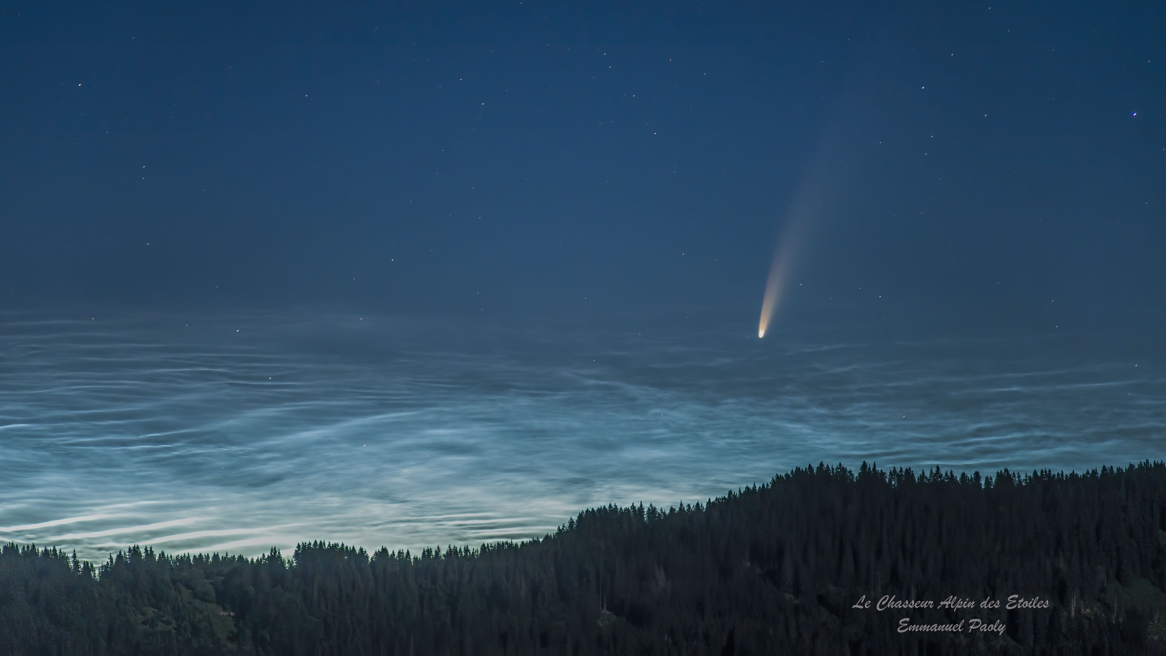 These silvery blue waves washing over a tree-lined horizon in the eastern French Alps are noctilucent clouds. From high in planet Earth's mesosphere, they reflect sunlight in this predawn skyscape taken on July 8. This summer, the night-shining clouds are not new to the northern high-latitudes. Comet NEOWISE is though. Also known as C/2020 F3, the comet was discovered in March by the Earth-orbiting Near Earth Object Wide-field Infrared Survey Explorer (NEOWISE) satellite. It's now emerging in morning twilight only just visible to the unaided eye from a clear location above the northeastern horizon.