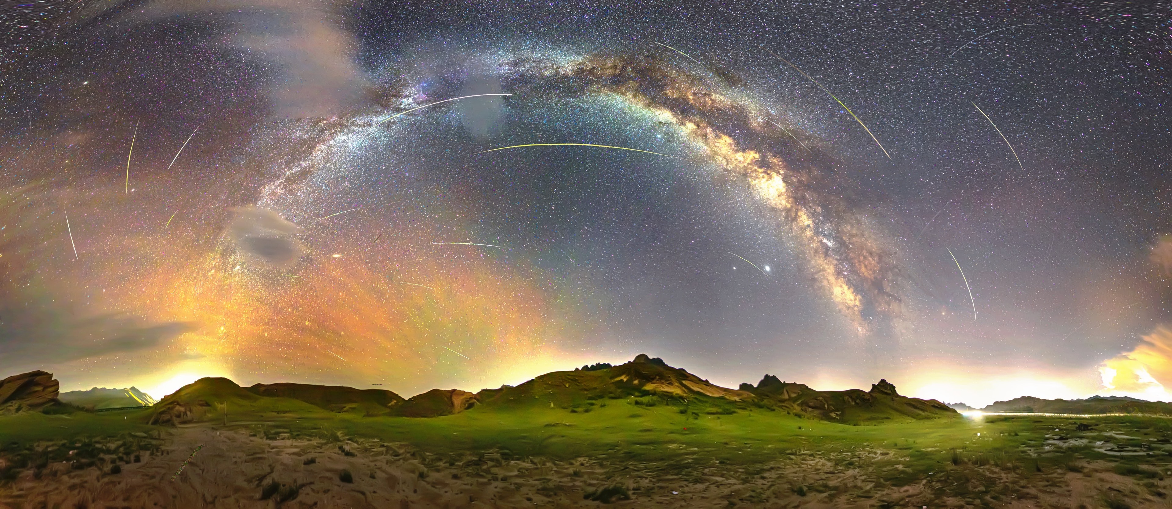Why would meteor trails appear curved? The arcing effect arises only because the image artificially compresses (nearly) the whole sky into a rectangle. The meteors are from the Perseid Meteor Shower that peaked last week. The featured multi-frame image combines not only different directions from the 360 projection, but different times when bright Perseid meteors momentarily streaked across the sky. All Perseid meteors can be traced back to the constellation Perseus toward the lower left, even the seemingly curved (but really straight) meteor trails.  Although Perseids always point back to their Perseus radiant, they can appear almost anywhere on the sky. The image was taken from Inner Mongolia, China, where grasslands meet sand dunes. Many treasures also visible in the busy night sky including the central arch of our Milky Way Galaxy, the planets Saturn and Jupiter toward the right, colorful airglow on the central left, and some relatively nearby Earthly clouds.  The Perseid Meteor Shower peaks every August.    Perseid Meteor Shower: Notable images submitted to APOD