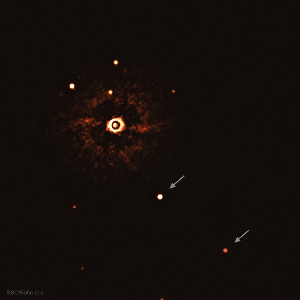 Do other stars have planets like our Sun? Previous evidence shows that they do, coming mostly from slight shifts in the star's light created by the orbiting planets.  Recently, however, and for the first time, a pair of planets has been directly imaged around a Sun-like star.  These exoplanets orbit the star designated TYC 8998-760-1 and are identified by arrows in the featured infrared image.  At 17 million years old, the parent star is much younger than the 5-billion-year age of our Sun.  Also, the exoplanets are both more massive and orbit further out than their Solar System analogues: Jupiter and Saturn. The exoplanets were found by the ESO's Very Large Telescope in Chile by their infrared glow – after the light from their parent star was artificially blocked.  As telescope and technology improve over the next decade, it is hoped that planets more closely resembling our Earth will be directly imaged.    Experts Debate: How will humanity first discover extraterrestrial life?