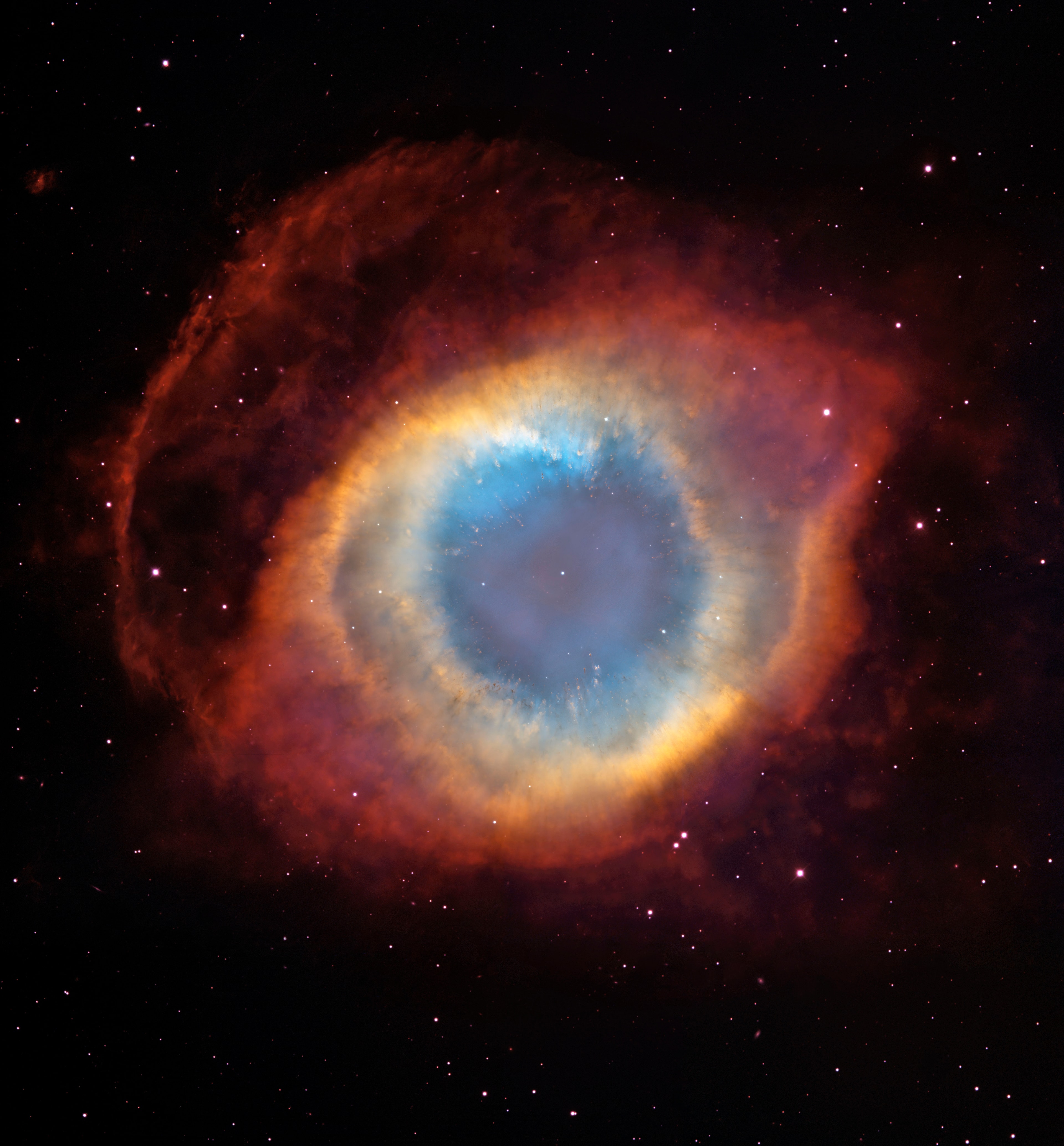 How did a star create the Helix nebula?  The shapes of planetary nebula like the Helix are important because they likely hold clues to how stars like the Sun end their lives.  Observations by the orbiting Hubble Space Telescope and the 4-meter Blanco Telescope in Chile, however, have shown the Helix is not really a simple helix.  Rather, it incorporates two nearly perpendicular disks as well as arcs, shocks, and even features not well understood.  Even so, many strikingly geometric symmetries remain.  How a single Sun-like star created such beautiful yet geometric complexity is a topic of research.  The Helix Nebula is the nearest planetary nebula to Earth, lies only about 700 light years away toward the constellation of Aquarius, and spans about 3 light-years.