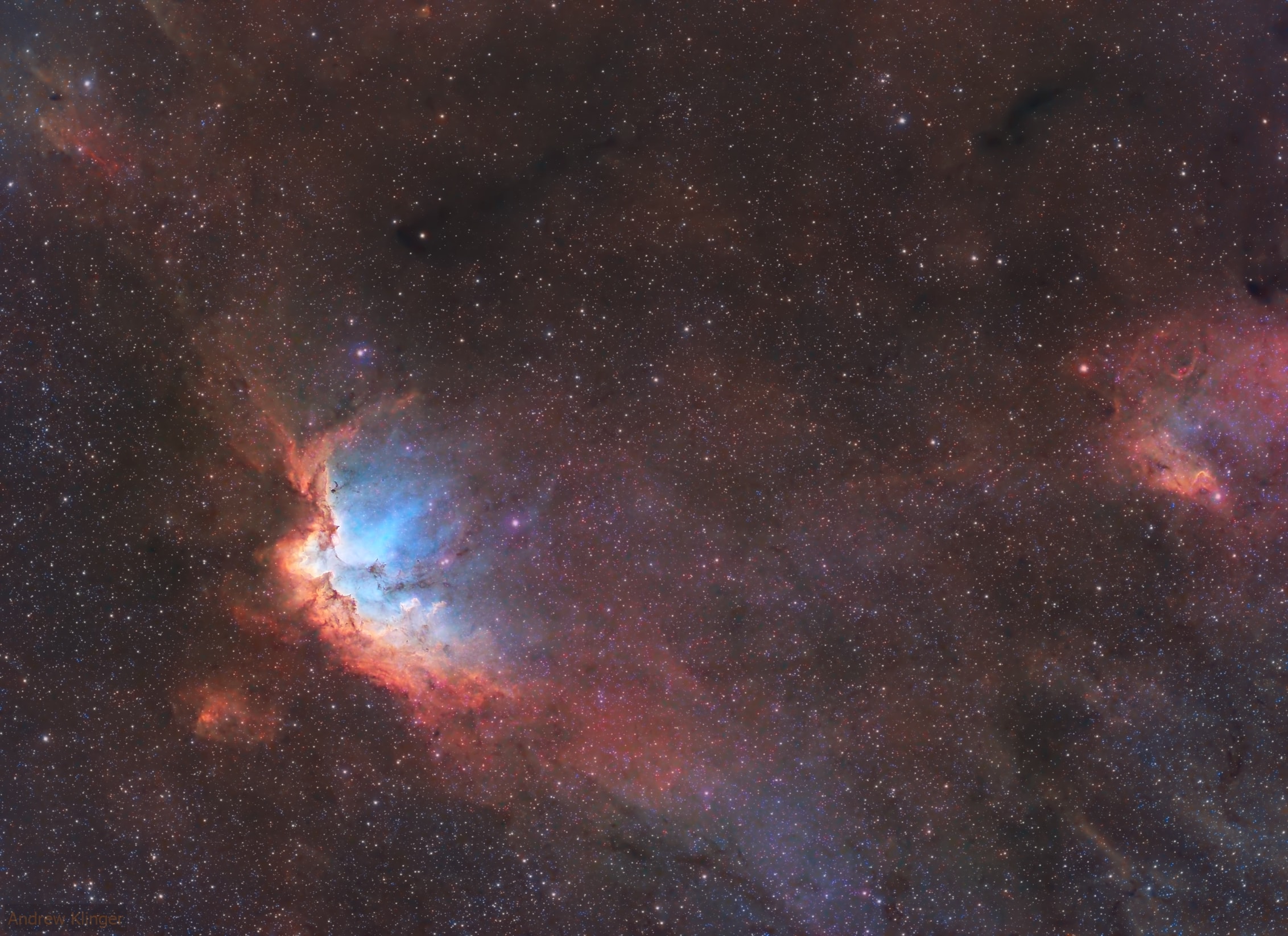 Open star cluster NGC 7380 is still embedded in its natal cloud of interstellar gas and dust popularly known as the Wizard Nebula. Seen on the left, with foreground and background stars along the plane of our Milky Way galaxy it lies some 8,000 light-years distant, toward the constellation Cepheus. In apparent size on the sky, a full moon would cover the 4 million year young cluster and associated nebula, normally much too faint to be seen by eye. Made with telescope and camera firmly planted on Earth, the image reveals multi light-year sized shapes and structures of cosmic gas and dust within the Wizard though, in a color palette made popular in Hubble Space Telescope images. Recorded with narrowband filters, the visible wavelength light from the nebula's hydrogen, oxygen, and sulfur atoms is transformed into green, blue, and red colors in the final digital composite.
