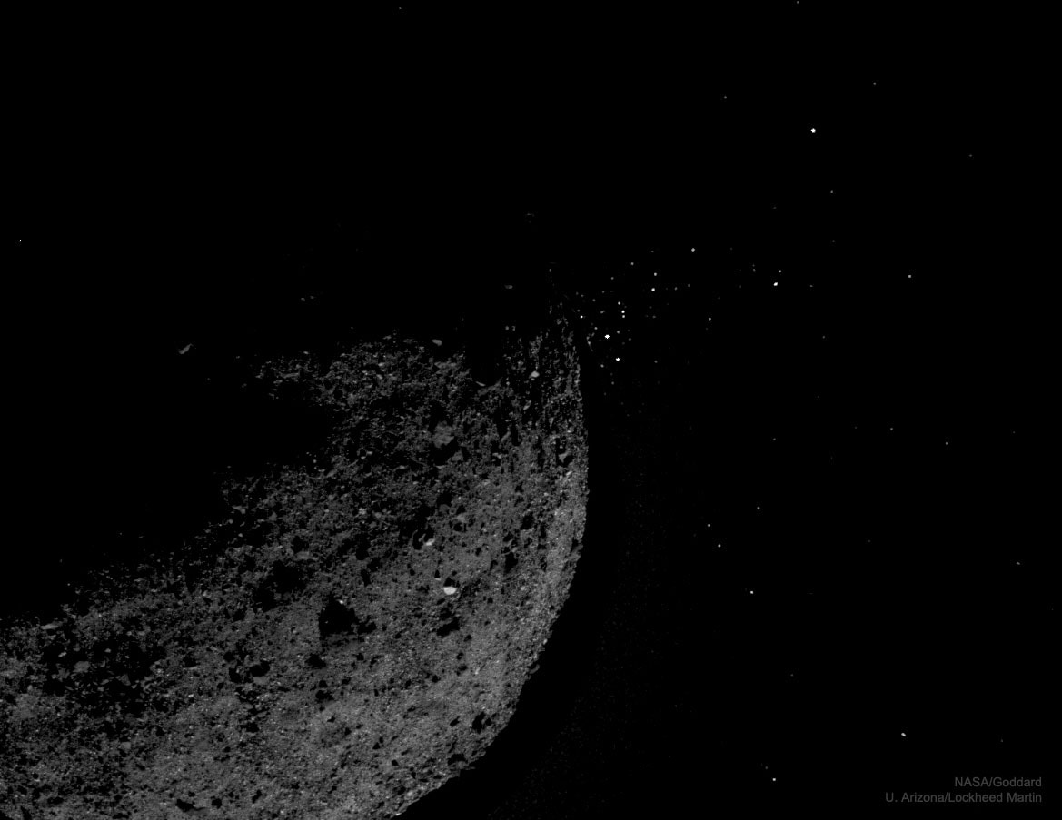 Why does asteroid Bennu eject gravel into space?  No one is sure. The discovery, occurring during several episodes by NASA's visiting OSIRIS-REx spacecraft, was unexpected. Leading ejection hypotheses include impacts by Sun-orbiting meteoroids, sudden thermal fractures of internal structures, and the sudden release of a water vapor jet.  The featured two-image composite shows an ejection event that occurred in early 2019, with sun-reflecting ejecta seen on the right. Data and simulations show that large gravel typically falls right back to the rotating 500-meter asteroid, while smaller rocks skip around the surface, and the smallest rocks completely escape the low gravity of the Earth approaching, diamond-shaped asteroid. Jets and surface ejection events were thought to be predominantly the domain of comets, responsible for their tails, comas, and later meteor showers on Earth. Robotic OSIRIS-REx arrived at 101955 Bennu in late 2018, and is planned to touchdown to collect a surface sample in October 2020. If all goes well, this sample will then be returned to Earth for a detailed analysis during 2023.  Bennu was chosen as the destination for OSIRIS-REx in part because its surface shows potential to reveal organic compounds from the early days of our Solar System, compounds that could have been the building blocks for life on Earth.    Experts Debate: How will humanity first discover extraterrestrial life?