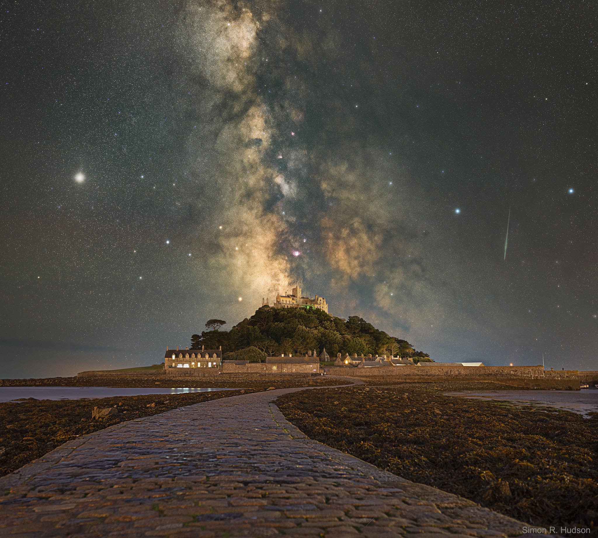Where do land and sky converge? On every horizon -- but in this case the path on the ground leads to St Michael's Mount (Cornish: Karrek Loos yn Koos), a small historic island in Cornwall, England. The Mount is usually surrounded by shallow water, but at low tide is spanned by a human-constructed causeway.  The path on the sky, actually the central band of our Milky Way Galaxy, also appears to lead to St Michael's Mount, but really lies far in the distance.  The red nebula in the Milky Way, just above the castle, is the Lagoon Nebula, while bright Jupiter shines to the left, and a luminous meteor flashes to the right.  The foreground and background images of this featured composite were taken on the same July night and from the same location. Although meteors are fleeting and the Milky Way disk shifts in the night as the Earth turns, Jupiter will remain prominent in the sunset sky into December.    Moon Occults Mars: Notable images submitted to APOD