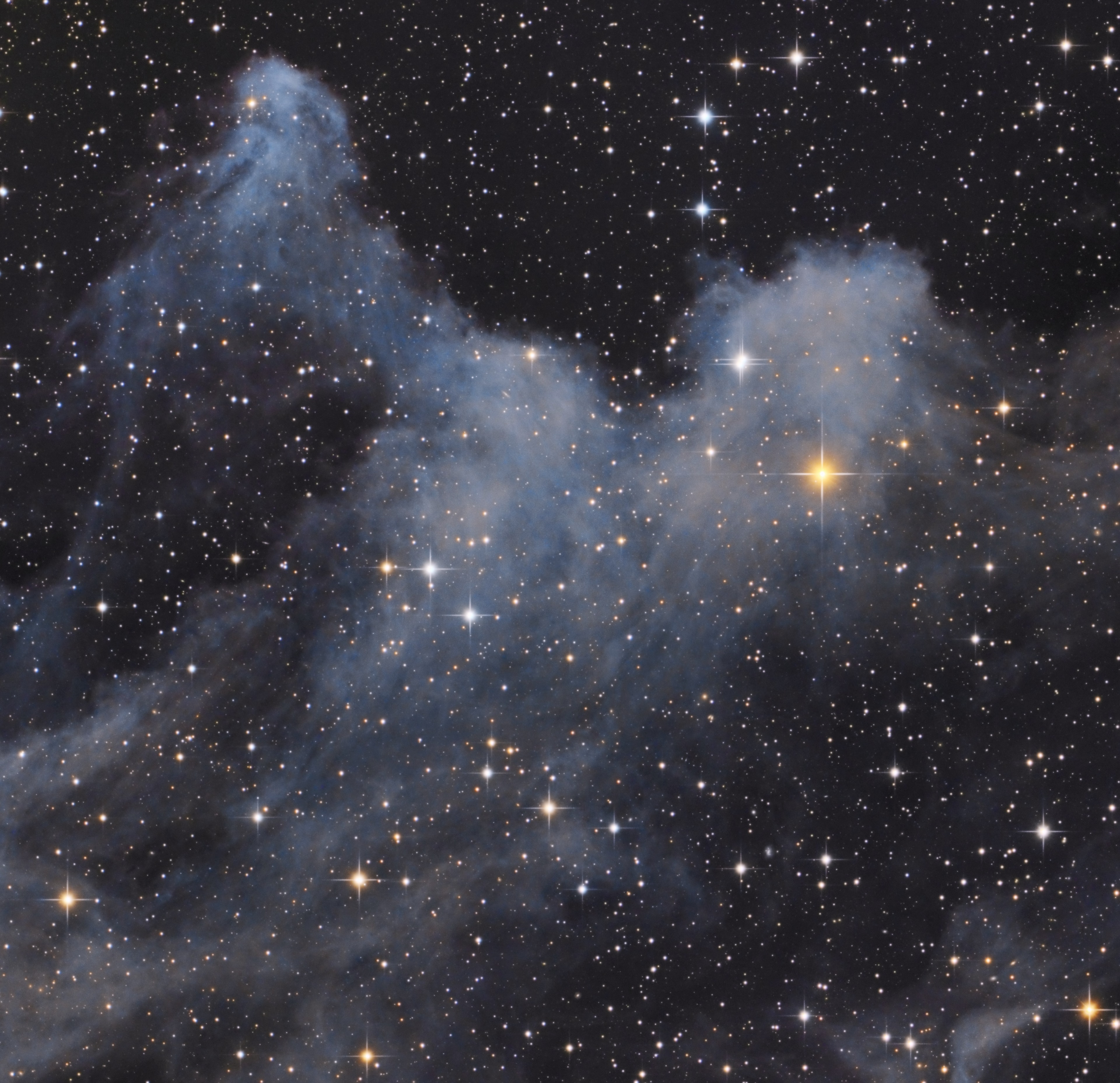 Inspired by the halloween season, this telescopic portrait captures a cosmic cloud with a scary visage. The interstellar scene lies within the dusty expanse of reflection nebula IC 2118 in the constellation Orion, the Hunter. IC 2118 is about 800 light-years from your neighborhood, close to bright bluish star Rigel at Orion's foot. Often identified as the Witch Head nebula for its appearance in a wider field of view it now rises before the witching hour. With spiky stars for eyes, the ghoulish apparition identified here seems to extend an arm many light-years long toward Orion's hot supergiant star. The source of illumination for IC 2118, Rigel is just beyond this frame at the upper left.