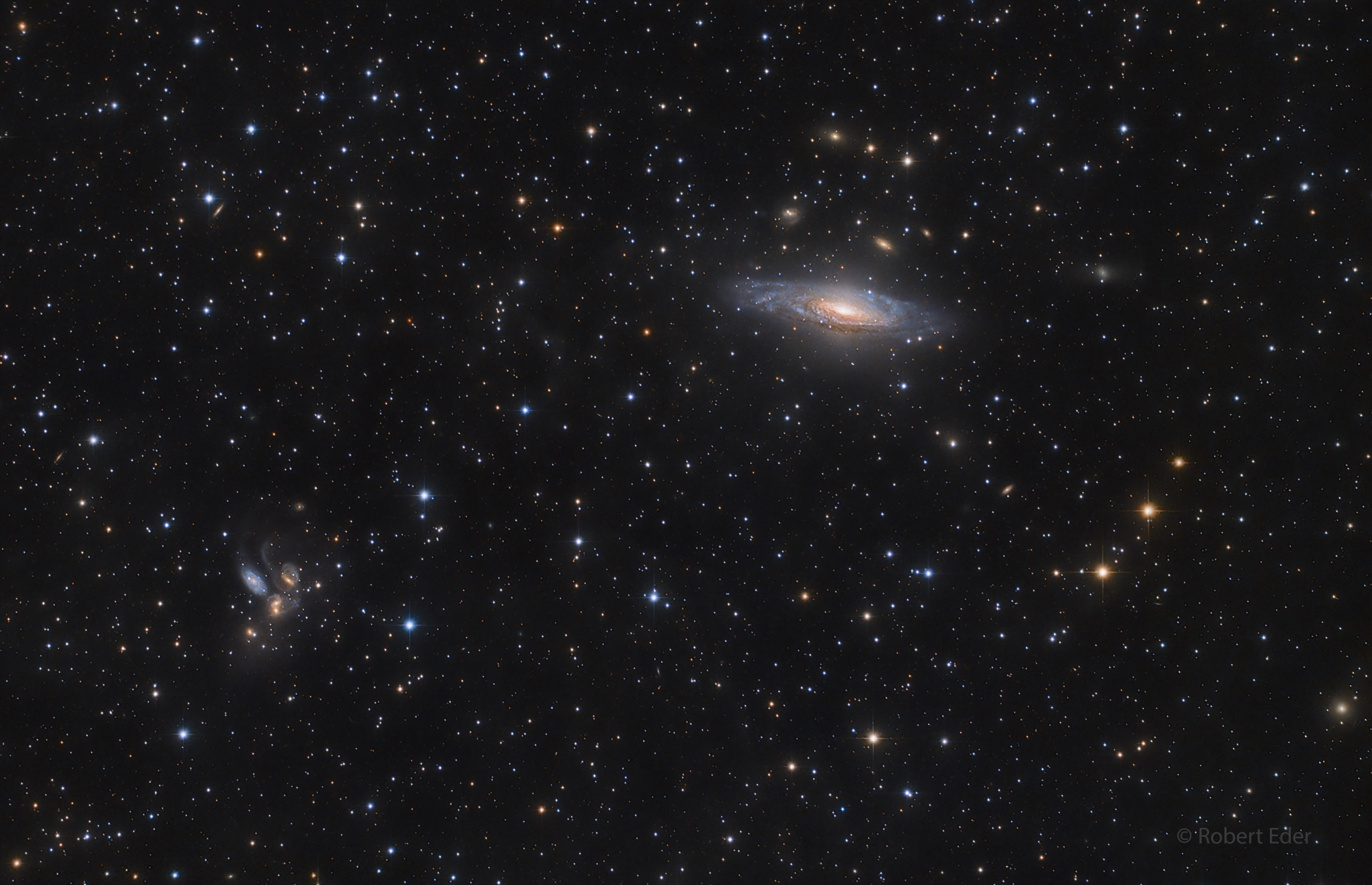 This sharp telescopic view reveals galaxies scattered beyond the stars of the Milky Way, at the northern boundary of the high-flying constellation Pegasus. Prominent at the upper right is NGC 7331. A mere 50 million light-years away, the large spiral is one of the brighter galaxies not included in Charles Messier's famous 18th century catalog. The disturbed looking group of galaxies at the lower left is well-known as Stephan's Quintet. About 300 million light-years distant, the quintet dramatically illustrates a multiple galaxy collision, its powerful, ongoing interactions posed for a brief cosmic snapshot. On the sky, the quintet and NGC 7331 are separated by about half a degree.