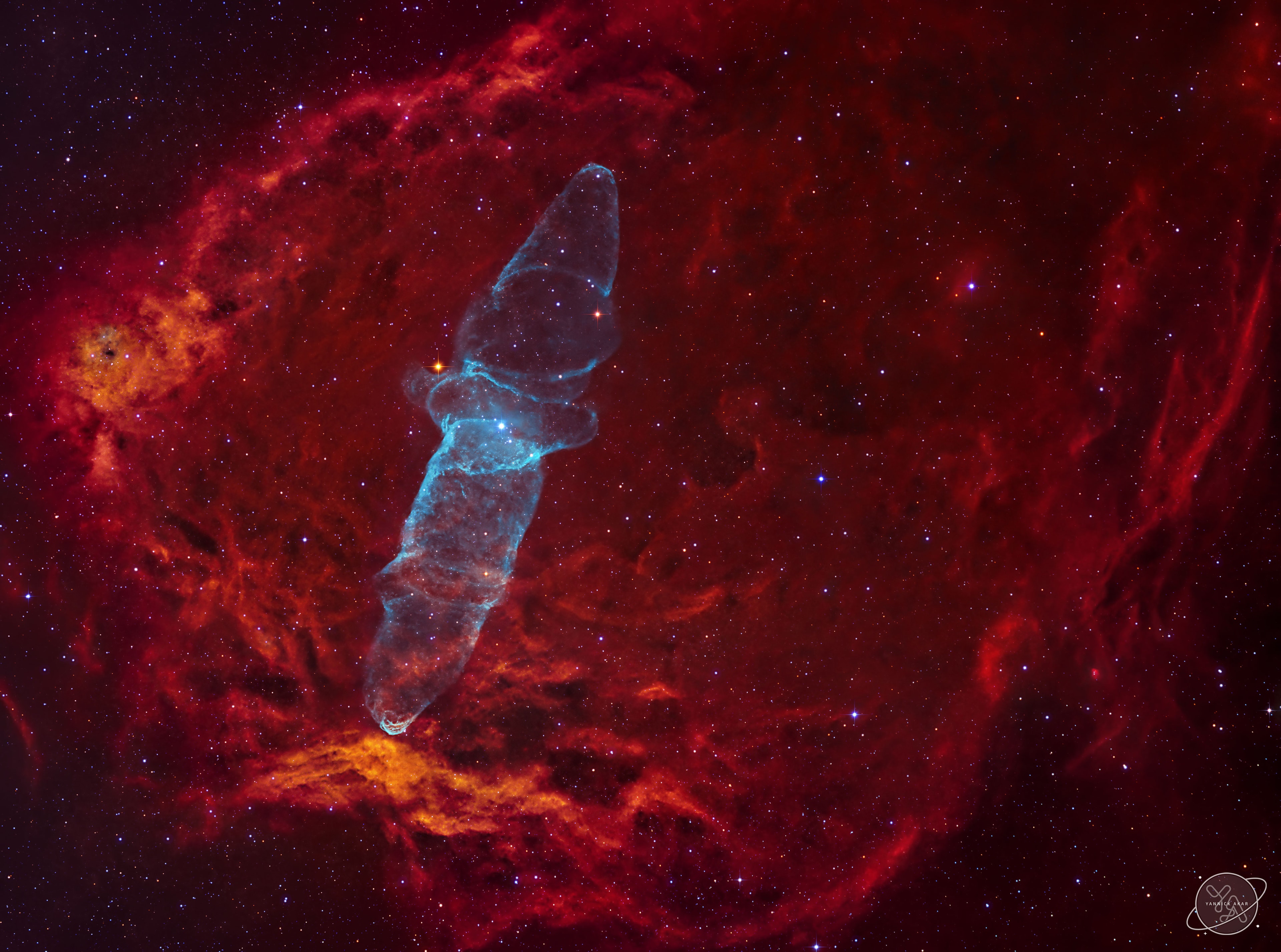 A very faint but very large squid-like nebula is visible in planet Earth's sky -- but inside a still larger bat.  The Giant Squid Nebula cataloged as Ou4, and Sh2-129 also known as the Flying Bat Nebula, are both caught in this cosmic scene toward the royal royal constellation Cepheus. Composed with 55 hours of narrowband image data, the telescopic field of view is 3 degrees or 6 Full Moons across. Discovered in 2011 by French astro-imager Nicolas Outters, the Squid Nebula's alluring bipolar shape is distinguished here by the telltale blue-green emission from doubly ionized oxygen atoms. Though apparently completely surrounded by the reddish hydrogen emission region Sh2-129, the true distance and nature of the Squid Nebula have been difficult to determine. Still, a more recent investigation suggests Ou4 really does lie within Sh2-129 some 2,300 light-years away. Consistent with that scenario, Ou4 would represent a spectacular outflow driven by HR8119, a triple system of hot, massive stars seen near the center of the nebula. The truly giant Squid Nebula would physically be nearly 50 light-years across.   New: APOD Mirror in Turkish from Rasyonalist