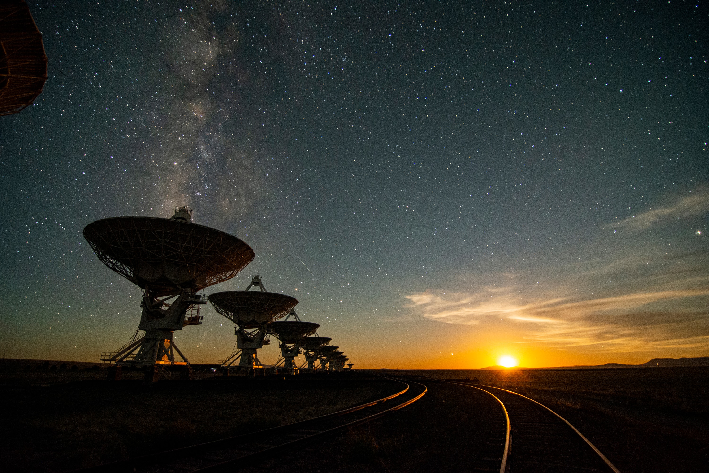 An inspirational sight, these giant dish antennas of the Karl G. Jansky Very Large Array (VLA) rise above the New Mexico desert at moonset.  Mounted on piers but transportable on railroad tracks to change the VLA’s configuration, its 27 operating antennas are each house-sized (25 meters across) and can be organized into an array spanning the size of a city (35 kilometers). A prolific radio astronomy workhorse, the VLA has been used to discover water on planet Mercury, radio-bright coronae around stars, micro-quasars in our Galaxy, gravitationally-induced Einstein rings around distant galaxies, and radio counterparts to cosmologically distant gamma-ray bursts. Its vast size has allowed astronomers to study the details of radio galaxies, super-fast cosmic jets, and map the center of our own Milky Way. Now 40 years since its dedication the VLA has been used in more than 14,000 observing projects and contributed to more than 500 Ph.D. dissertations. On October 10, the National Radio Astronomy Observatory will host a day-long online celebration of the VLA at 40 featuring virtual tours and presentations on the history, operations, science, and future of the Very Large Array.