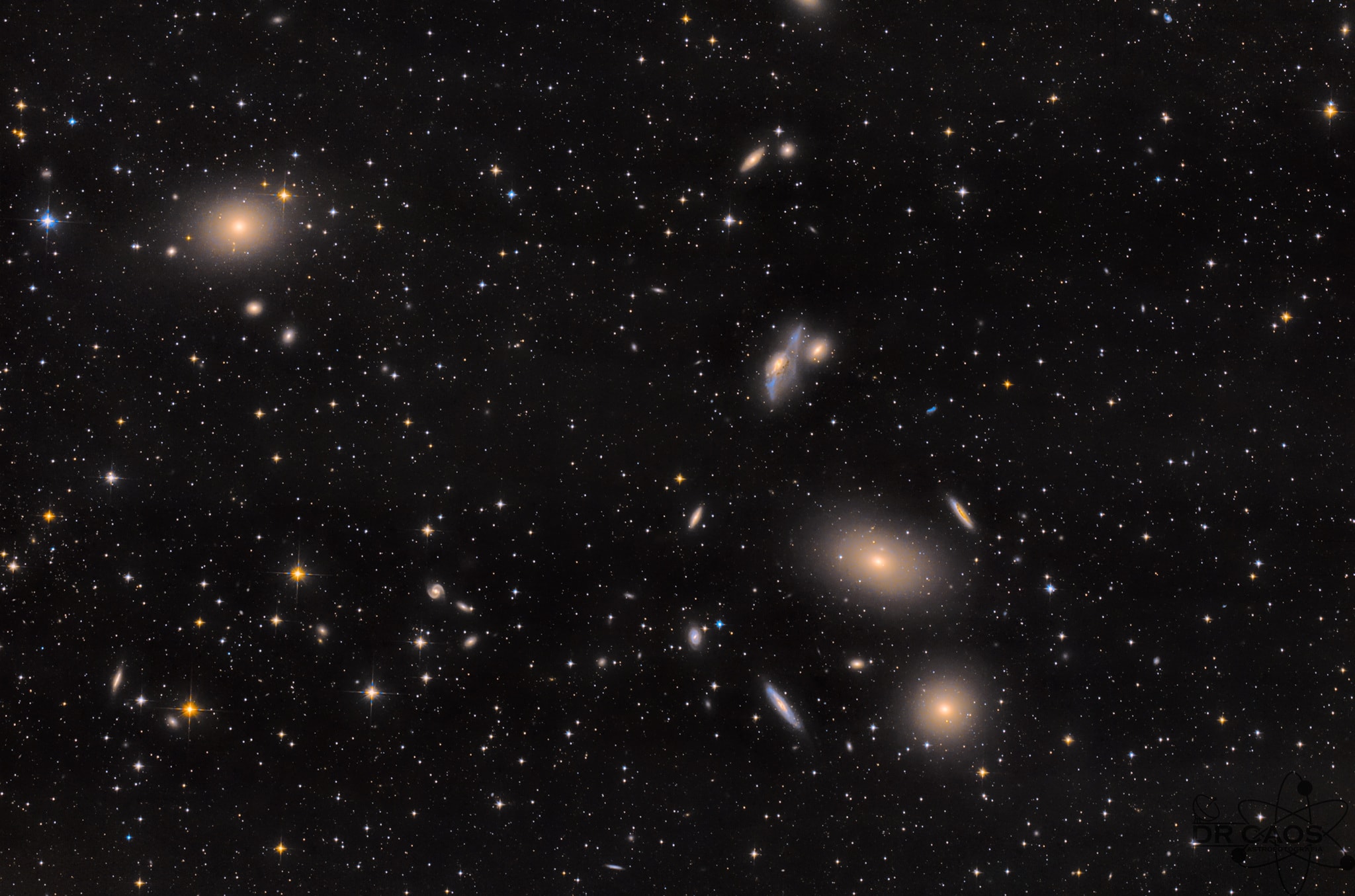 Galaxies of the Virgo Cluster are scattered across this deep telescopic field of view. The cosmic scene spans about three Full Moons, captured in dark skies near Jalisco, Mexico, planet Earth. About 50 million light-years distant, the Virgo Cluster is the closest large galaxy cluster to our own local galaxy group. Prominent here are Virgo's bright elliptical galaxies from the Messier catalog, M87 at the top left, and M84 and M86 seen (bottom to top) below and right of center. M84 and M86 are recognized as part of Markarian's Chain, a visually striking line-up of galaxies vertically on the right side of this frame. Near the middle of the chain lies an intriguing interacting pair of galaxies, NGC 4438 and NGC 4435, known to some as Markarian's Eyes. Of course giant elliptical galaxy M87 dominates the Virgo cluster. It's the home of a super massive black hole, the first black hole ever imaged by planet Earth's Event Horizon Telescope.