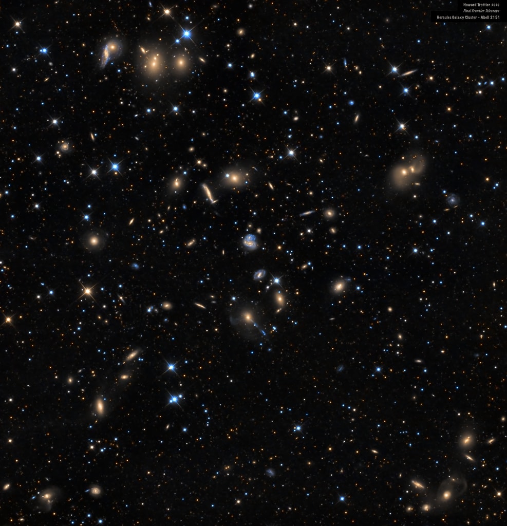 These are galaxies of the Hercules Cluster, an archipelago of island universes a mere 500 million light-years away. Also known as Abell 2151, this cluster is loaded with gas and dust rich, star-forming spiral galaxies but has relatively few elliptical galaxies, which lack gas and dust and the associated newborn stars. The colors in this deep composite image clearly show the star forming galaxies with a blue tint and galaxies with older stellar populations with a yellowish cast. The sharp picture spans about 1/2 degree across the cluster center, corresponding to over 4 million light-years at the cluster's estimated distance. Diffraction spikes around brighter foreground stars in our own Milky Way galaxy are produced by the imaging telescope's mirror support vanes. In the cosmic vista many galaxies seem to be colliding or merging while others seem distorted - clear evidence that cluster galaxies commonly interact. In fact, the Hercules Cluster itself may be seen as the result of ongoing mergers of smaller galaxy clusters and is thought to be similar to young galaxy clusters in the much more distant, early Universe.