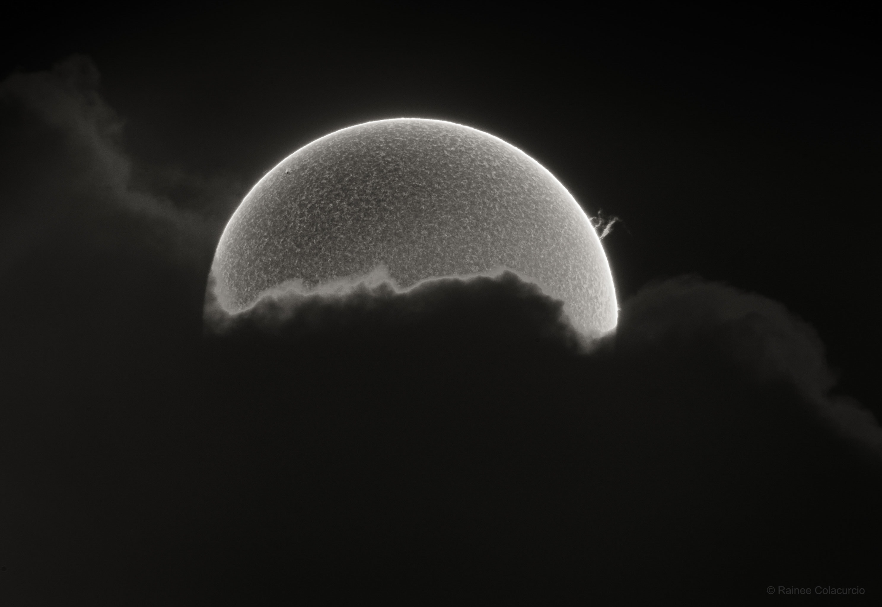 What's happening to the Sun? Clearly, the Sun's lower half is hidden behind a thick cloud.  Averaging over the entire Earth, clouds block the Sun about 2/3rds of the time, although much less over many land locations. On the Sun's upper right is a prominence of magnetically levitating hot gas. The prominence might seem small but it could easily envelop our  Earth and persist for over a month.  The featured image is a combination of two exposures, one optimizing the cloud and prominence, and the other optimizing the Sun's texture.  Both were taken about an hour apart with the same camera and from the same location in Lynnwood, Washington, USA.  The shaggy texture derives from the Sun's chromosphere, an atmospheric layer that stands out in the specifically exposed color.  The uniformity of the texture shows the surface to be relatively calm, indicative of a Sun just past the solar minimum in its 11-year cycle. In the years ahead, the Sun will progress toward a more active epoch where sunspots, prominences, and ultimately auroras on Earth will be more common: solar maximum.    Gallery: Notable images of the Halloween Blue Moon of 2020 submitted to APOD