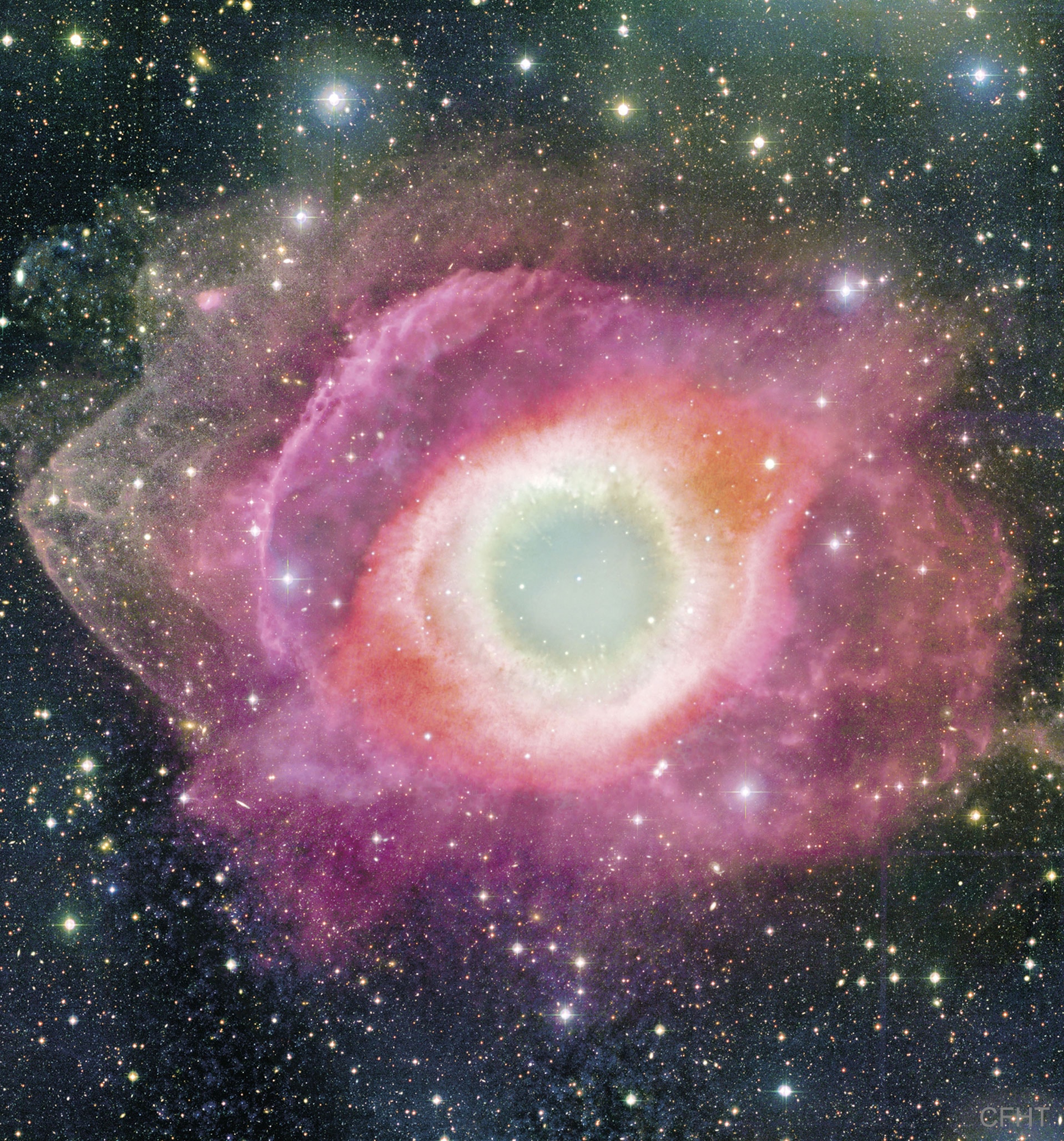 Will our Sun look like this one day?  The Helix Nebula is one of brightest and closest examples of a planetary nebula, a gas cloud created at the end of the life of a Sun-like star. The outer gasses of the star expelled into space appear from our vantage point as if we are looking down a helix. The remnant central stellar core, destined to become a white dwarf star, glows in light so energetic it causes the previously expelled gas to fluoresce. The Helix Nebula, given a technical designation of NGC 7293, lies about 700 light-years away towards the constellation of the Water Bearer (Aquarius) and spans about 2.5 light-years. The featured picture was taken with the Canada-France-Hawaii Telescope (CFHT) located atop a dormant volcano in Hawaii, USA. A close-up of the inner edge of the Helix Nebula shows complex gas knots of unknown origin.