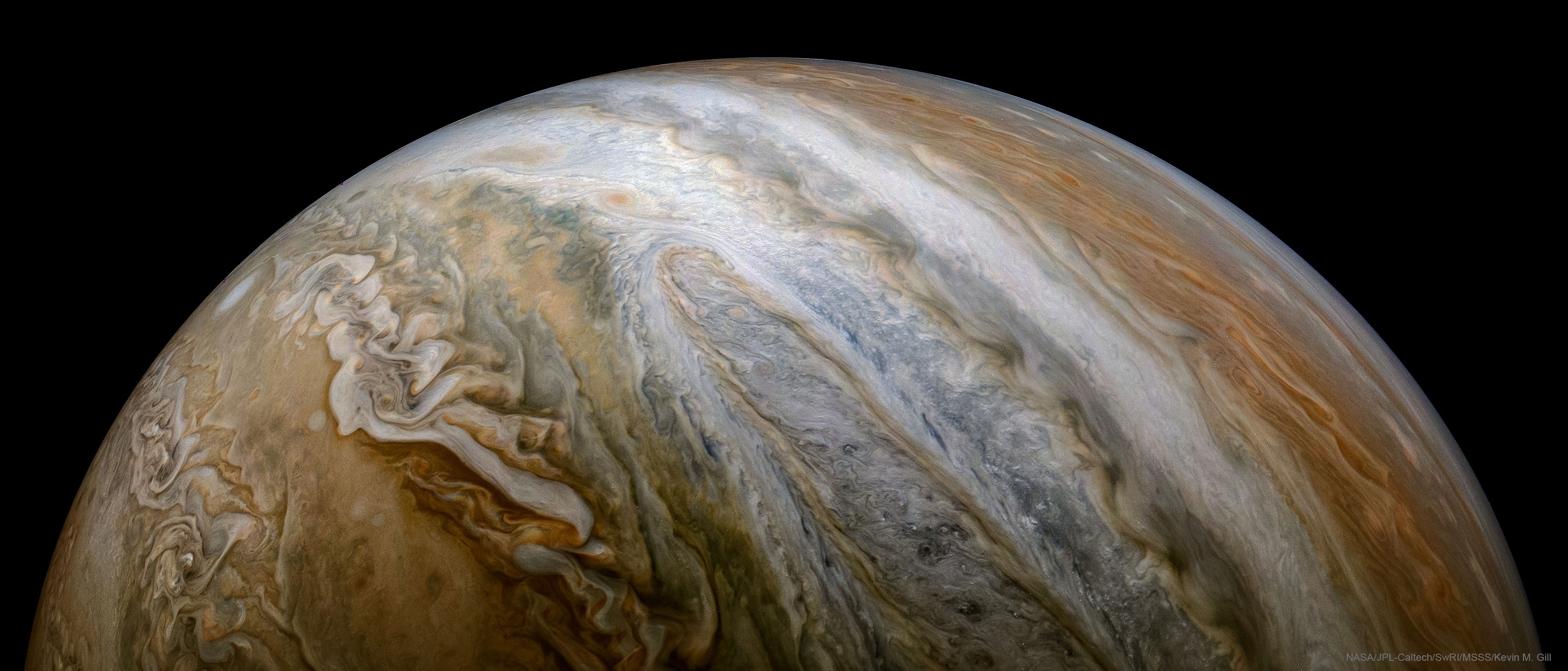Why do colorful cloud bands encircle Jupiter? Jupiter's top atmospheric layer is divided into light zones and dark belts that go all the way around the giant planet. It is high horizontal winds -- in excess of 300 kilometers per hour -- that cause the zones to spread out planet-wide. What causes these strong winds remains a topic of research.  Replenished by upwelling gas, zonal bands are thought to include relatively opaque clouds of ammonia and water that block light from lower and darker atmospheric levels.  One light-colored zone is shown in great detail in the featured vista taken by the robotic Juno spacecraft in 2017.  Jupiter's atmosphere is mostly clear and colorless hydrogen and helium, gases that are not thought to contribute to the gold and brown colors.  What compounds create these colors is another active topic of research -- but is hypothesized to involve small amounts of sunlight-altered sulfur and carbon.  Many discoveries have been made from Juno's data, including that water composes an unexpectedly high 0.25 percent of upper-level cloud molecules near Jupiter's equator, a finding important not only for understanding Jovian currents but for the history of water in the entire Solar System.