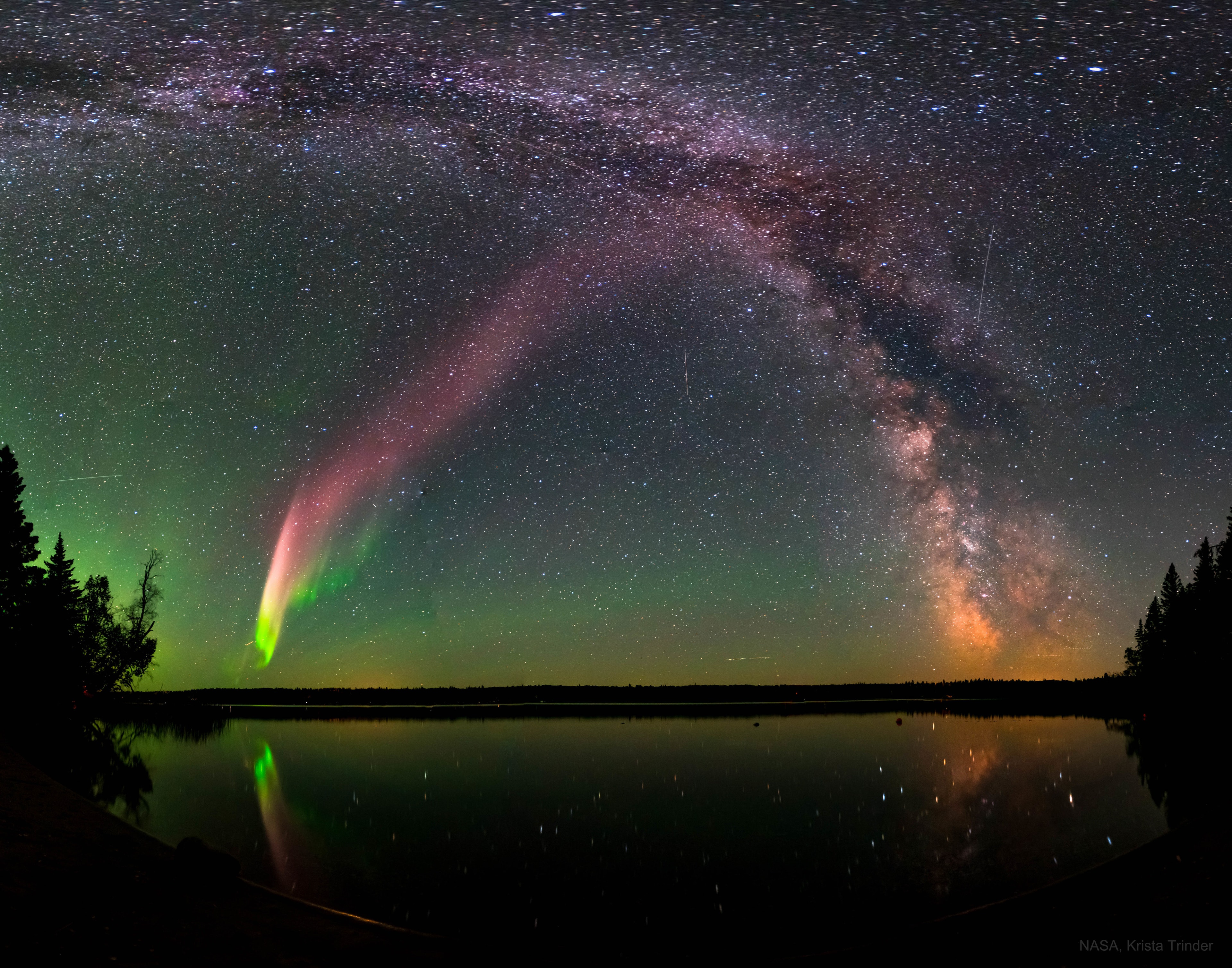 What's creating these long glowing streaks in the sky? No one is sure.  Known as Strong Thermal Emission Velocity Enhancements (STEVEs), these luminous light-purple sky ribbons may resemble regular auroras, but recent research reveals significant differences. A STEVE's great length and unusual colors, when measured precisely, indicate that it may be related to a subauroral ion drift (SAID), a supersonic river of hot atmospheric ions thought previously to be invisible.  Some STEVEs are now also thought to be accompanied by green picket fence structures, a series of sky slats that can appear outside of the main auroral oval that does not involve much glowing nitrogen. The featured wide-angle composite image shows a STEVE in a dark sky above Childs Lake, Manitoba, Canada in 2017, crossing in front of the central band of our Milky Way Galaxy.