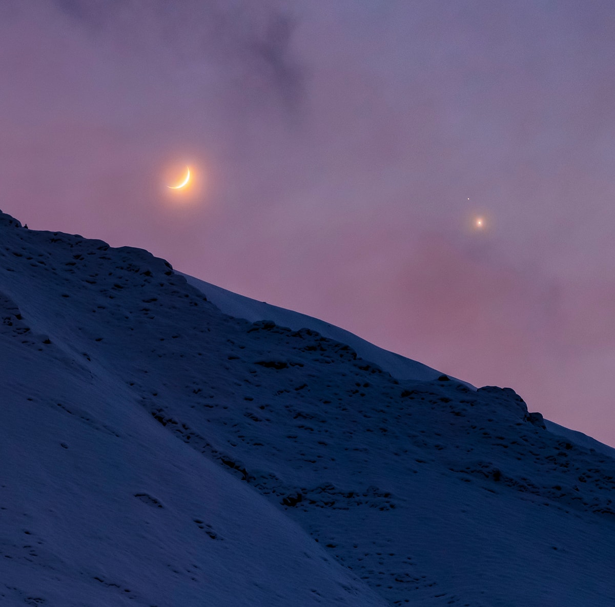 How close will Jupiter and Saturn be at their Great Conjunction? Consider this beautiful triple conjunction of Moon, Jupiter and Saturn captured through clouds in the wintry twilight. The telephoto view looks toward the western horizon and the Alborz Mountains in Iran after sunset on December 17. The celestial gathering makes it easy to see Jupiter and fainter Saturn are separated on that date by roughly the diameter of the waxing crescent Moon. On the day of their Great Conjunction, solstice day December 21, Jupiter and Saturn may seem to nearly merge though. In their closest conjunction in 400 years they will be separated on the sky by only about 1/5 the apparent diameter of the Moon. By then the two largest worlds in the Solar System and their moons will be sharing the same field of view in telescopes around planet Earth.