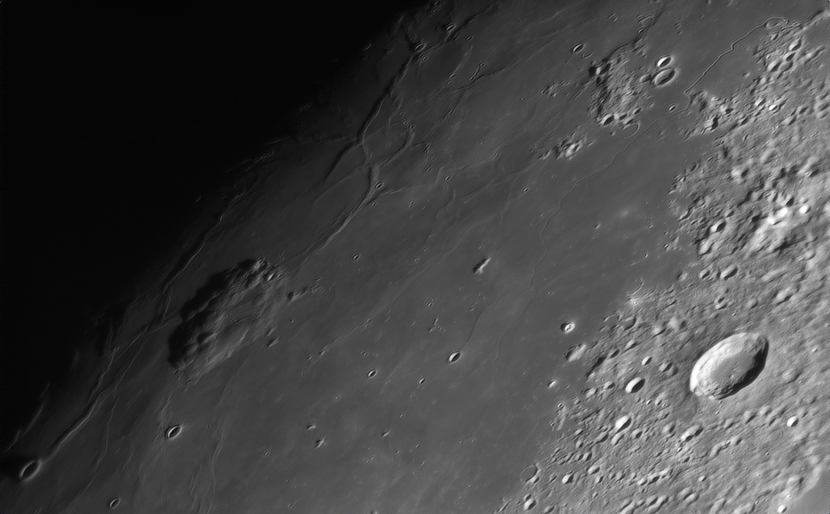 Mons Rumker, a 70 kilometer wide complex of volcanic domes, rises some 1100 meters above the vast, smooth lunar mare known as Oceanus Procellarum, the Ocean of Storms. Daylight came to the area late last month. The lunar terminator, the shadow line between night and day, runs diagonally across the left side in this telescopic close-up of a waxing gibbous Moon from November 27. China's Chang'e-5 mission landing site is also in the frame. The probe's lander-ascender combination touch down on the lunar surface within a region right of center and north of Mons Rumker's domes on December 1. On December 3 the ascender left the Ocean of Storms carrying 2 kilograms of lunar material for return to planet Earth.