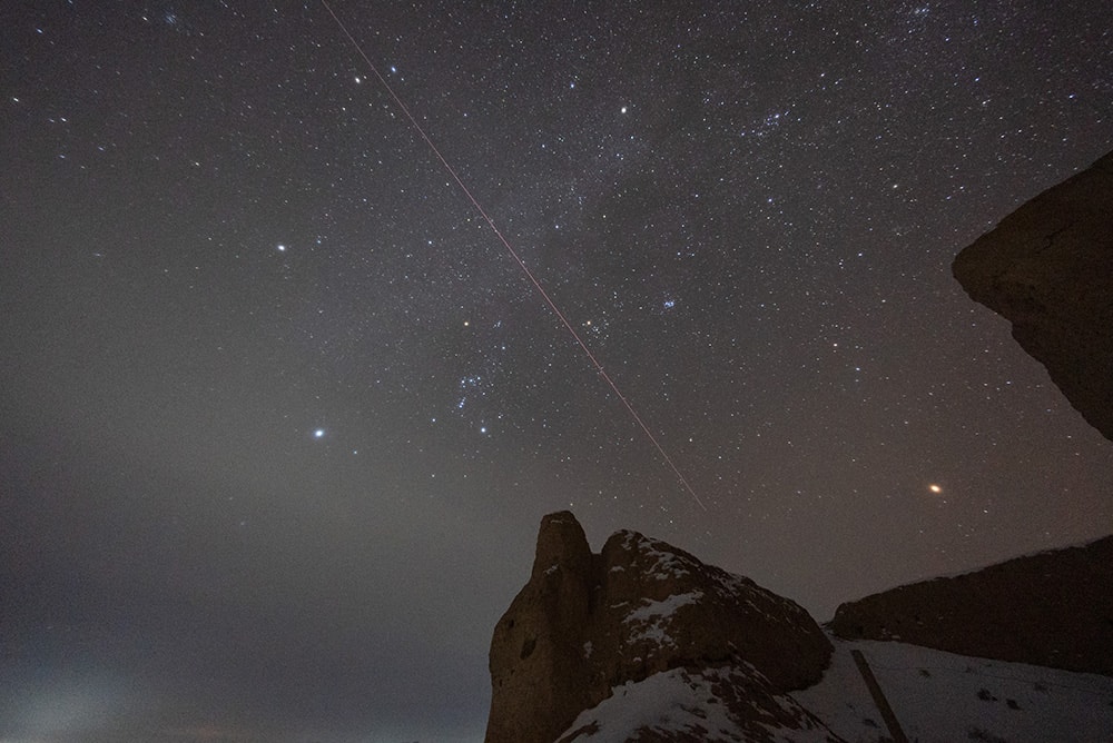 Familiar stars of a northern winter's night shine in this night skyview, taken near Zhangye, Gansu, China and the border with Inner Mongolia. During the early hours of December 17 Orion is near center in the single exposure that captures a fireball streaking across the sky, almost as bright as yellowish Mars shining on the right. Splitting Gemini's twin bright stars Castor and Pollux near the top of the frame, the fireball's trail and timing are consistent with the second skipping atmospheric entry of the Chang'e 5 mission's returner capsule. The returner capsule was successfully recovered after landing in Inner Mongolia, planet Earth with about 2 kilograms of lunar material on board. The lunar sample is thought to contain relatively young material collected near the Mons Rumker region of the Moon's Oceanus Procellarum. Launched on November 23 UT, China's Chang'e 5 mission is the first lunar sample return mission since the Soviet Union’s Luna 24 mission in 1976.