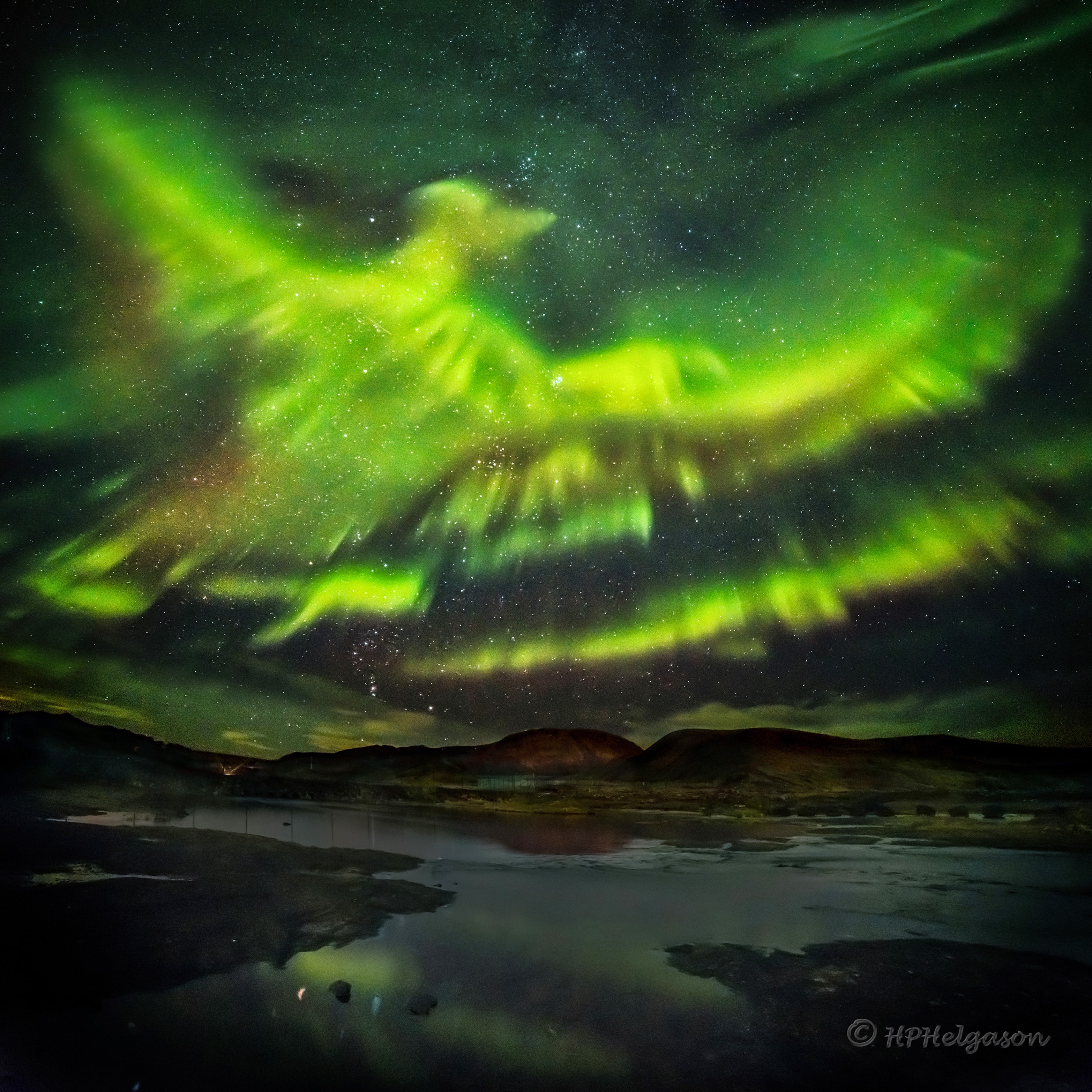 All of the other aurora watchers had gone home. By 3:30 am in Iceland, on a quiet September night, much of that night's auroras had died down. Suddenly, unexpectedly, a new burst of particles streamed down from space, lighting up the Earth's atmosphere once again. This time, surprisingly, pareidoliacally, the night lit up with an  amazing shape reminiscent of a giant phoenix. With camera equipment at the ready, two quick sky images were taken, followed immediately by a third of the land.  The mountain in the background is Helgafell, while the small foreground river is called Kaldá, both located about 30 kilometers north of Iceland's capital Reykjavík. Seasoned skywatchers will note that just above the mountain, toward the left, is the constellation of Orion, while the Pleiades star cluster is also visible just above the frame center.  The 2016 aurora, which lasted only a minute and was soon gone forever --  would possibly be dismissed as an fanciful fable -- were it not captured in the featured, digitally-composed, image mosaic.    Almost Hyperspace: Random APOD Generator
