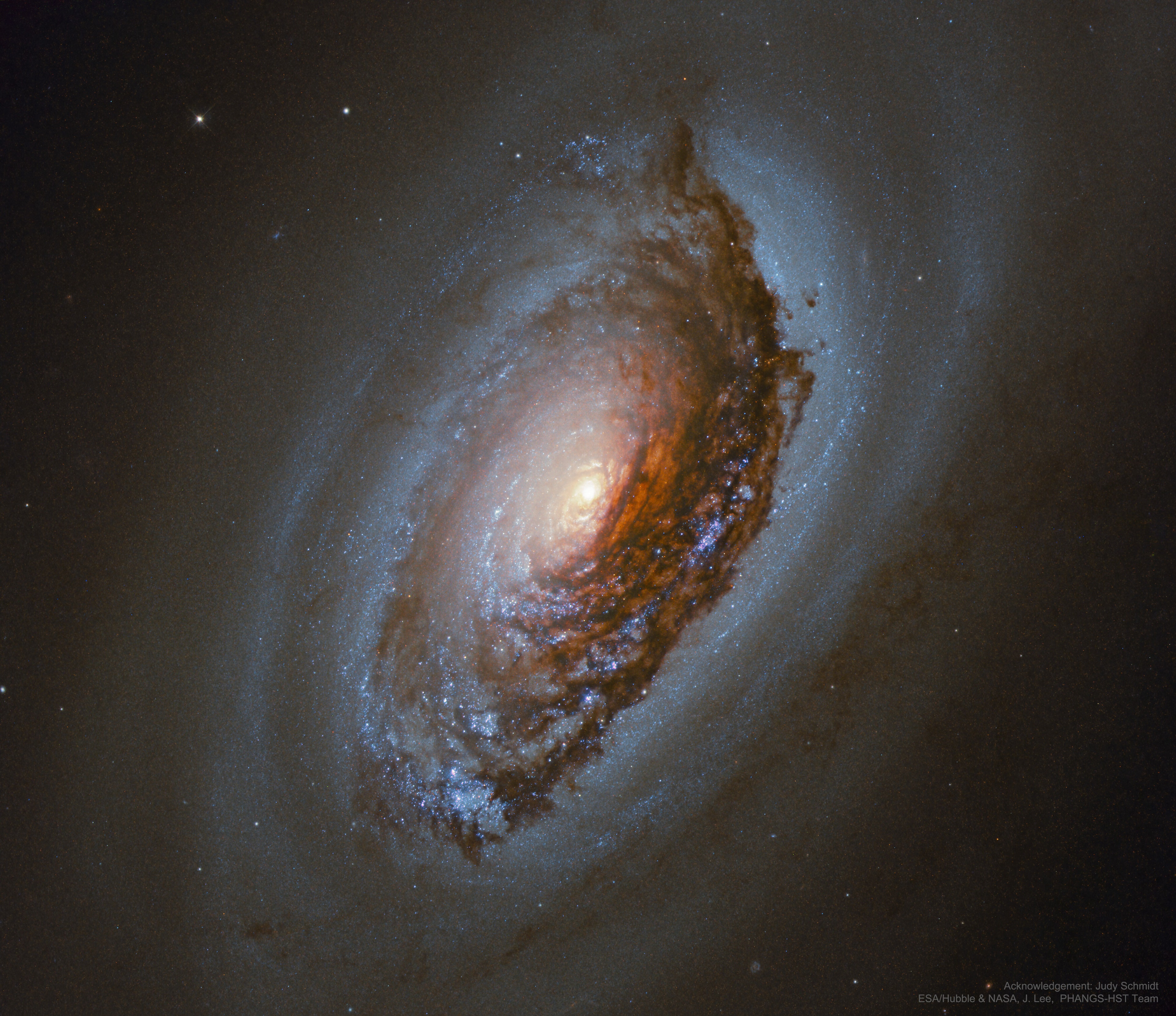 Who knows what evil lurks in the eyes of galaxies? The Hubble knows -- or in the case of spiral galaxy M64 -- is helping to find out. Messier 64, also known as the Evil Eye or Sleeping Beauty Galaxy, may seem to have evil in its eye because all of its stars rotate in the same direction as the interstellar gas in the galaxy's central region, but in the opposite direction in the outer regions. Captured here in great detail by the Earth-orbiting Hubble Space Telescope, enormous dust clouds obscure the near-side of M64's central region, which are laced with the telltale reddish glow of hydrogen associated with star formation.  M64 lies about 17 million light years away, meaning that the light we see from it today left when the last common ancestor between humans and chimpanzees roamed the Earth.  The dusty eye and bizarre rotation are likely the result of a billion-year-old merger of two different galaxies.