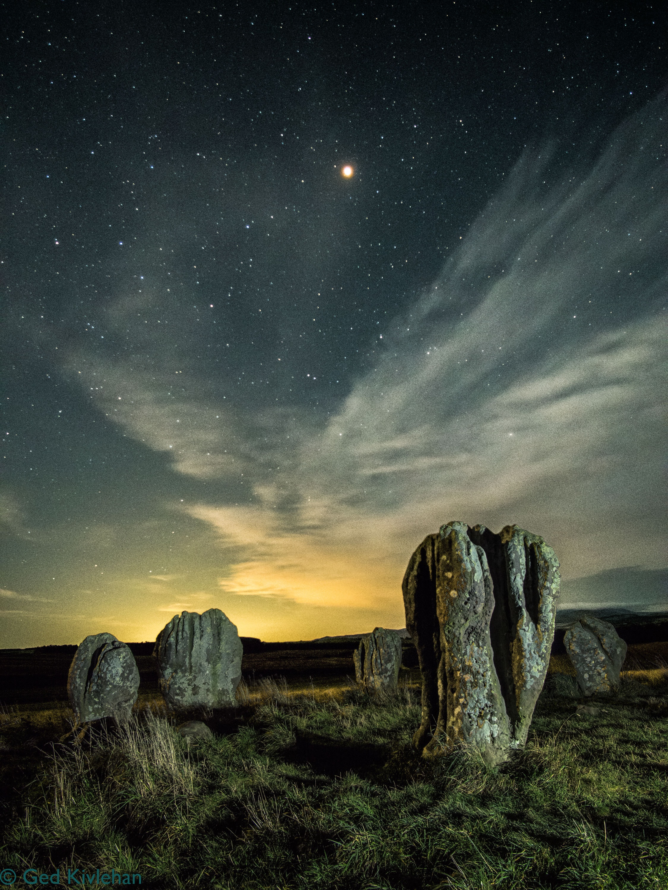 Why are these large stones here? One the more famous stone circles is the Duddo Five Stones of Northumberland, England.  Set in the open near the top of a modest incline, a short hike across empty fields will bring you to unusual human -sized stones that are unlike anything surrounding them. The grooved, pitted, and deeply weathered surfaces of the soft sandstones are consistent with being placed about 4000 years ago -- but placed for reasons now unknown.  The featured image -- a composite of two consecutive images taken from the same location -- was captured last October under a starry sky when the Earth was passing near Mars, making the red planet unusually large and bright.  Mars remains visible at sunset, although increasingly close to the horizon over the next few months.   APOD via Instagram in: English, Indonesian, Persian, and Portuguese