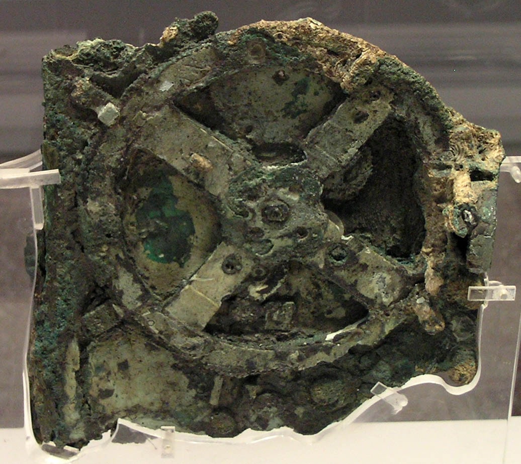 No one knew that 2,000 years ago, the technology existed to build such a device.  The Antikythera mechanism, pictured, is now widely regarded as the first computer. Found at the bottom of the sea aboard a decaying Greek ship, its complexity prompted decades of study, and even today some of its functions likely remain unknown.  X-ray images of the device, however, have confirmed that a main function of its numerous clock-like wheels and gears is to create a portable, hand-cranked, Earth-centered, orrery of the sky, predicting future star and planet locations as well as lunar and solar eclipses.  The corroded core of the Antikythera mechanism's largest gear is featured, spanning about 13 centimeters, while the entire mechanism was 33 centimeters high, making it similar in size to a large book. Recently, modern computer modeling of missing components is allowing for the creation of a more complete replica of this surprising ancient machine.