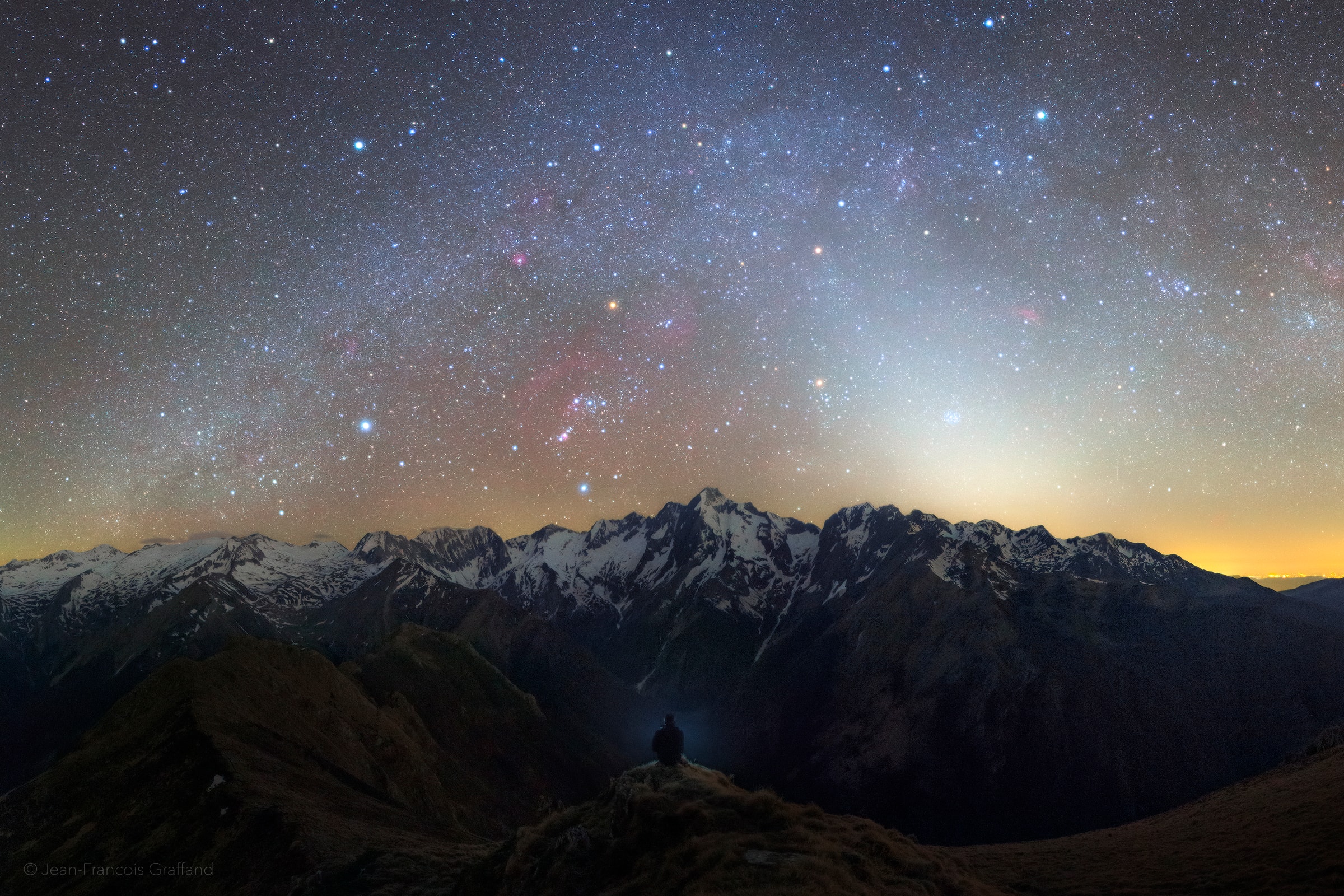 An intense band of zodiacal light is captured in this serene mountain and night skyscape from April 7. The panoramic view was recorded after three hours of hiking from a vantage looking west after sunset across the Pyrenees in southern France. At 2838 meters altitude, Mont Valier is the tallest peak near center. In the sky above, the familiar stars of Orion and the northern winter Milky Way are approaching the rugged western horizon. At the shoulder of Orion, Betelgeuse is one of three bright yellowish celestial beacons. It forms a triangle with fellow red giant star Aldebaran located below Betelgeuse and to the right, and the red planet Mars. Mars shines just under the band of the Milky Way, still immersed in the bright zodiacal light.   Tournament Earth: Vote for your favorite image from NASA's Earth Observatory