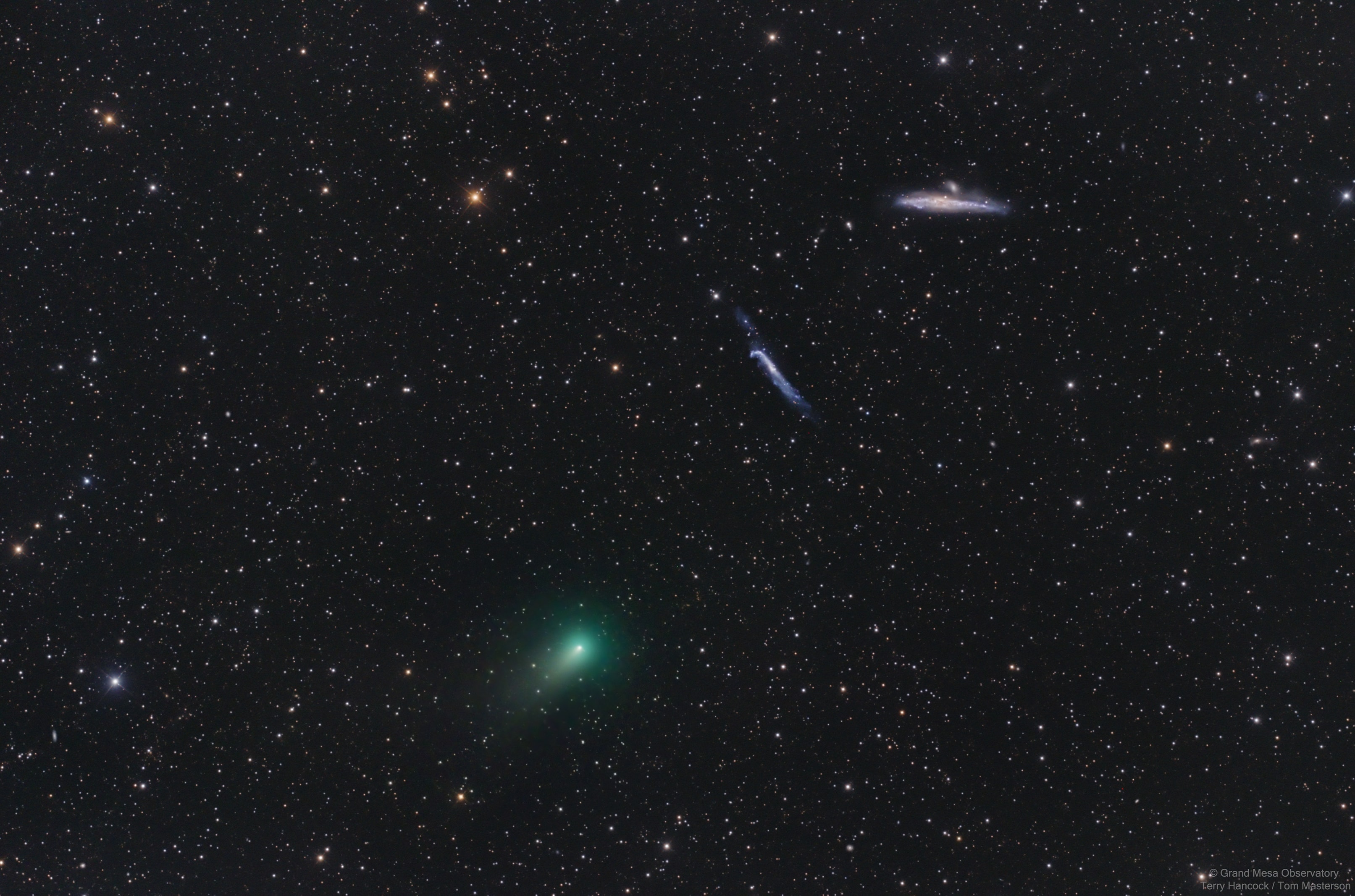 Closest to the Sun on March 1, and closest to planet Earth on April 23, this Comet ATLAS (C/2020 R4) shows a faint greenish coma and short tail in this pretty, telescopic field of view. Captured at its position on May 5, the comet was within the boundaries of northern constellation Canes Venatici (the Hunting Dogs), and near the line-of-sight to intriguing background galaxies popularly known as the Whale and the Hockey Stick. Cetacean in appearance but Milky Way sized, NGC 4631 is a spiral galaxy seen edge-on at the top right, some 25 million light-years away. NGC 4656/7 sports the bent-stick shape of interacting galaxies below and left of NGC 4631. In fact, the distortions and mingling trails of gas detected at other wavelengths suggest the cosmic Whale and Hockey Stick have had close encounters with each other in their distant past. Outbound and only about 7 light-minutes from Earth this Comet ATLAS should revisit the inner solar system in just under 1,000 years.