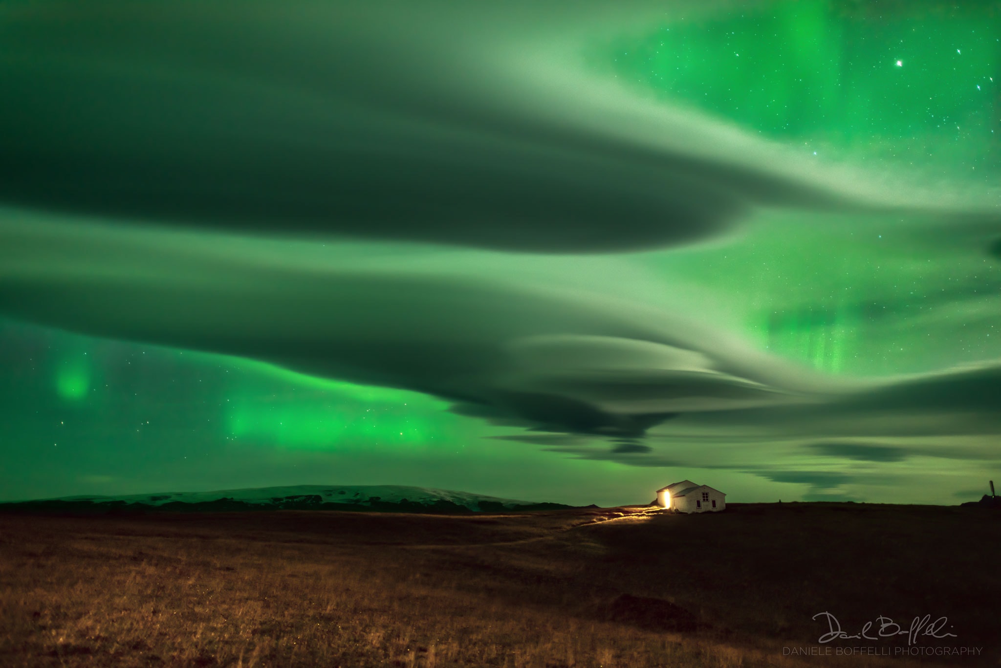 Auroras usually occur high above the clouds.  The auroral glow is created when fast-moving particles ejected from the Sun impact the Earth's magnetosphere, from which charged particles spiral along the Earth's magnetic field to strike atoms and molecules high in the Earth's atmosphere.  An oxygen atom, for example, will glow in the green light commonly emitted by an aurora after being energized by such a collision.  The lowest part of an aurora will typically occur about 100 kilometers up, while most clouds exist only below about 10 kilometers.  The relative heights of clouds and auroras are shown clearly in the featured picture in 2015 from Dyrholaey, Iceland. There, a determined astrophotographer withstood high winds and initially overcast skies in an attempt to capture aurora over a picturesque lighthouse, only to take, by chance, the featured picture including elongated lenticular clouds, along the way.    Follow APOD on Instagram in: English, Farsi, Indonesian, Persian, or Portuguese