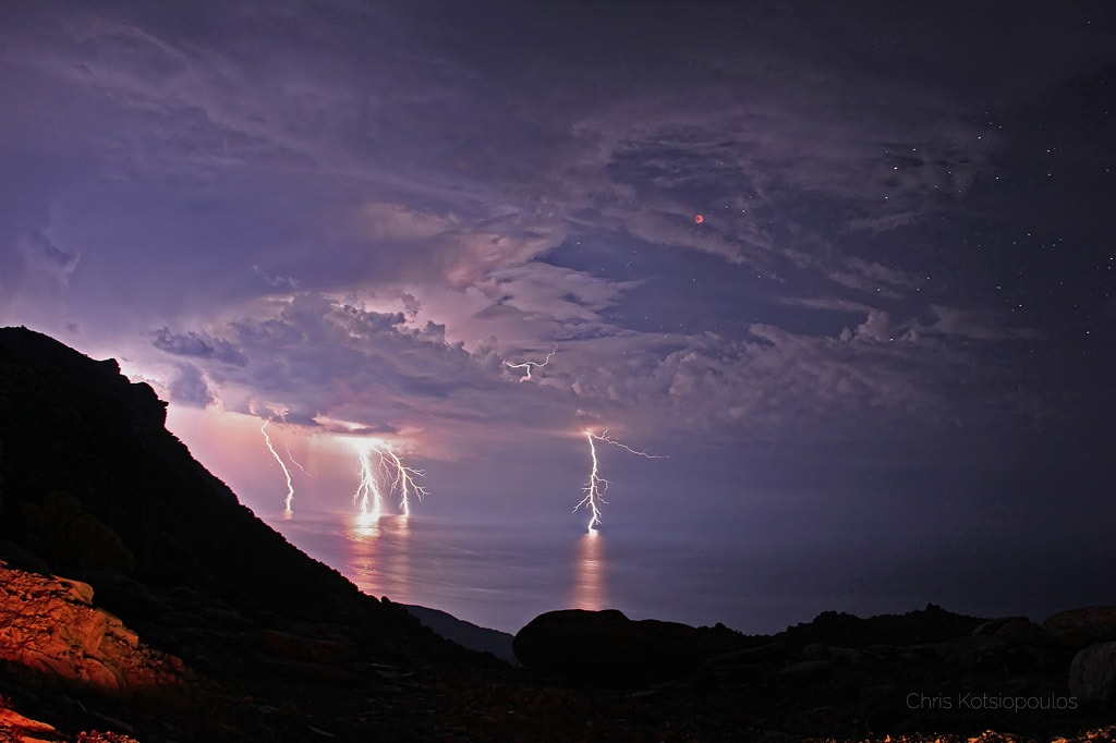 Thunderstorms almost spoiled this view of the spectacular 2011 June 15 total lunar eclipse. Instead, storm clouds parted for 10 minutes during the total eclipse phase and lightning bolts contributed to the dramatic sky. Captured with a 30-second exposure the scene also inspired one of the more memorable titles (thanks to the astrophotographer) in APOD's now 25-year history.  Of course, the lightning reference clearly makes sense, and the shadow play of the dark lunar eclipse was widely viewed across planet Earth in Europe, Africa, Asia, and Australia. The picture itself, however, was shot from the Greek island of Ikaria at Pezi. That area is known as "the planet of the goats" because of the rough terrain and strange looking rocks.  The next total lunar eclipse will occur on Wednesday.   Details: Total Lunar Eclipse on 2021 May 26
