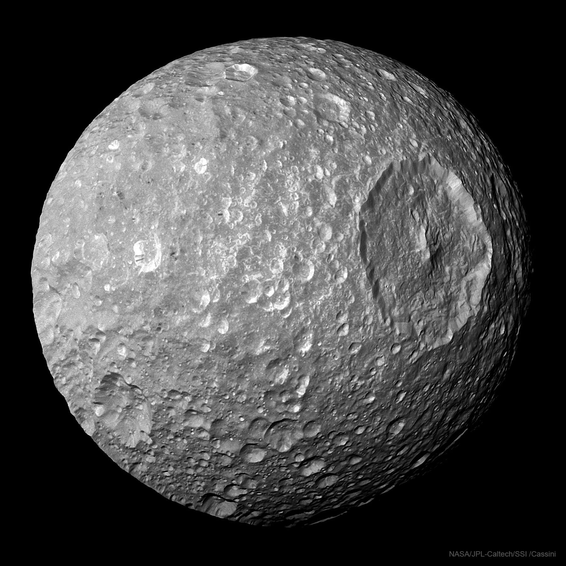Whatever hit Mimas nearly destroyed it.  What remains is one of the largest impact craters on one of Saturn's smallest round moons.  Analysis indicates that a slightly larger impact would have destroyed Mimas entirely.  The huge crater, named Herschel after the 1789 discoverer of Mimas, Sir William Herschel, spans about 130 kilometers and is featured here. Mimas' low mass produces a surface gravity just strong enough to create a spherical body but weak enough to allow such relatively large surface features. Mimas is made of mostly water ice with a smattering of rock - so it is accurately described as a big dirty snowball. The featured image was taken during the closest-ever flyby of the robot spacecraft Cassini past Mimas in 2010 while in orbit around Saturn.   Interactive: Take a trek across Mimas