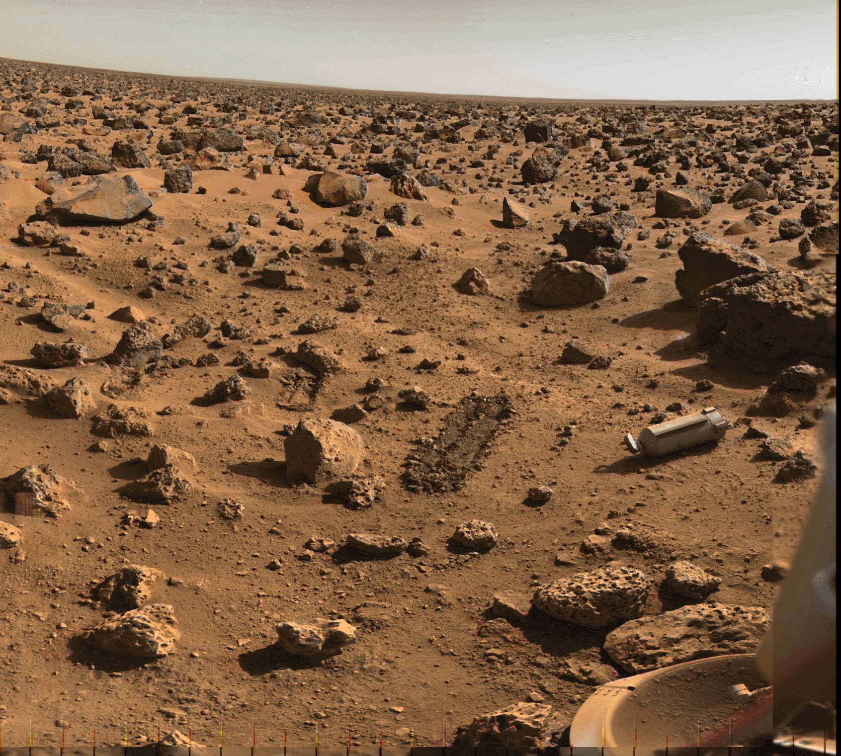 sive Utopia Planitia on Mars is strewn with rocks and boulders in this 1976 image. Constructed from the Viking 2 lander's color and black and white image data, the scene approximates the appearance of the high northern martian plain to the human eye. For scale, the prominent rounded rock near center is about 20 centimeters (just under 8 inches) across.  Farther back on the right side of the frame the a dark angular boulder spans about 1.5 meters (5 feet). Also in view are two trenches dug by the lander's sampler arm, the ejected protective shroud that covered the soil collector head, and one of the lander's dust covered footpads at the lower right. On May 14, China’s Zhurong Mars rover successfully touchdown on Mars and has returned the first images of` its landing site in Utopia Planitia.