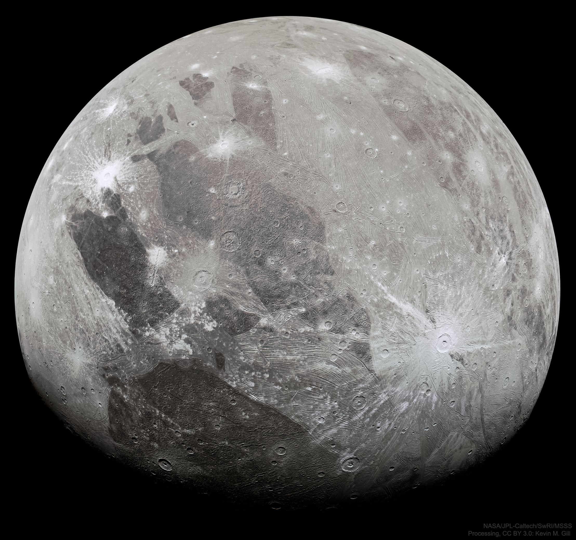 What does the largest moon in the Solar System look like?  Jupiter's moon Ganymede, larger than even Mercury and Pluto, has an icy surface speckled with bright young craters overlying a mixture of older, darker, more cratered terrain laced with grooves and ridges.  The cause of the grooved terrain remains a topic of research, with a leading hypothesis relating it to shifting ice plates.  Ganymede is thought to have an ocean layer that contains more water than Earth -- and might contain life.  Like Earth's Moon, Ganymede keeps the same face towards its central planet, in this case Jupiter.  The featured image was captured last week by NASA's robotic Juno spacecraft as it passed only about 1000 kilometers above the immense moon.  The close pass reduced Juno's orbital period around Jupiter from 53 days to 43 days.  Juno continues to study the giant planet's high gravity, unusual magnetic field, and complex cloud structures.    Last week's solar eclipse: Notable images submitted to APOD