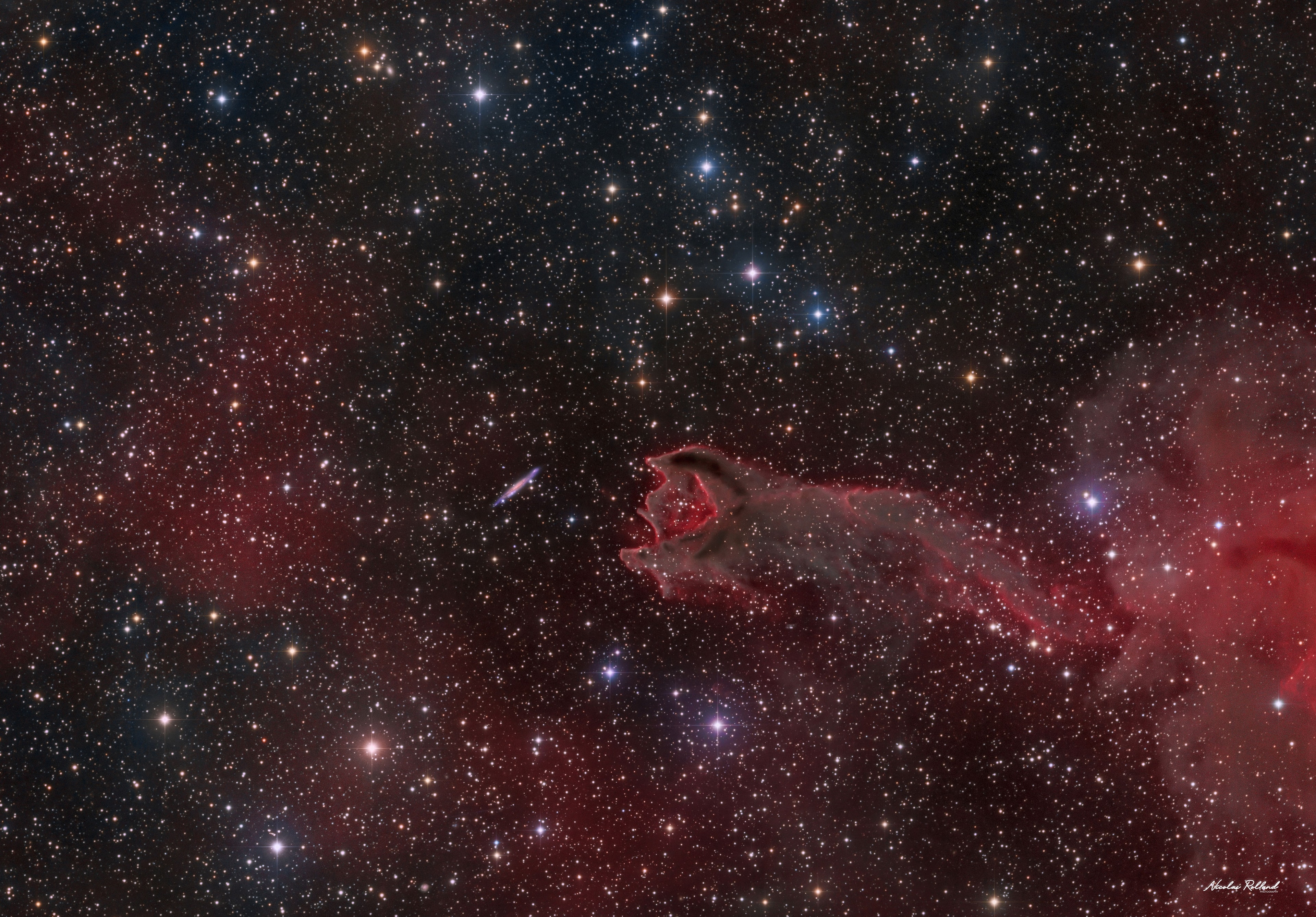 Can a gas cloud grab a galaxy?  It's not even close.  The "claw" of this odd looking "creature" in the featured photo is a gas cloud known as a cometary globule.  This globule, however, has ruptured.  Cometary globules are typically characterized by dusty heads and elongated tails.  These features cause cometary globules to have visual similarities to comets, but in reality they are very much different.  Globules are frequently the birthplaces of stars, and many show very young stars in their heads. The reason for the rupture in the head of this object is not yet known. The galaxy to the left of the globule is huge, very far in the distance, and only placed near CG4 by chance superposition.