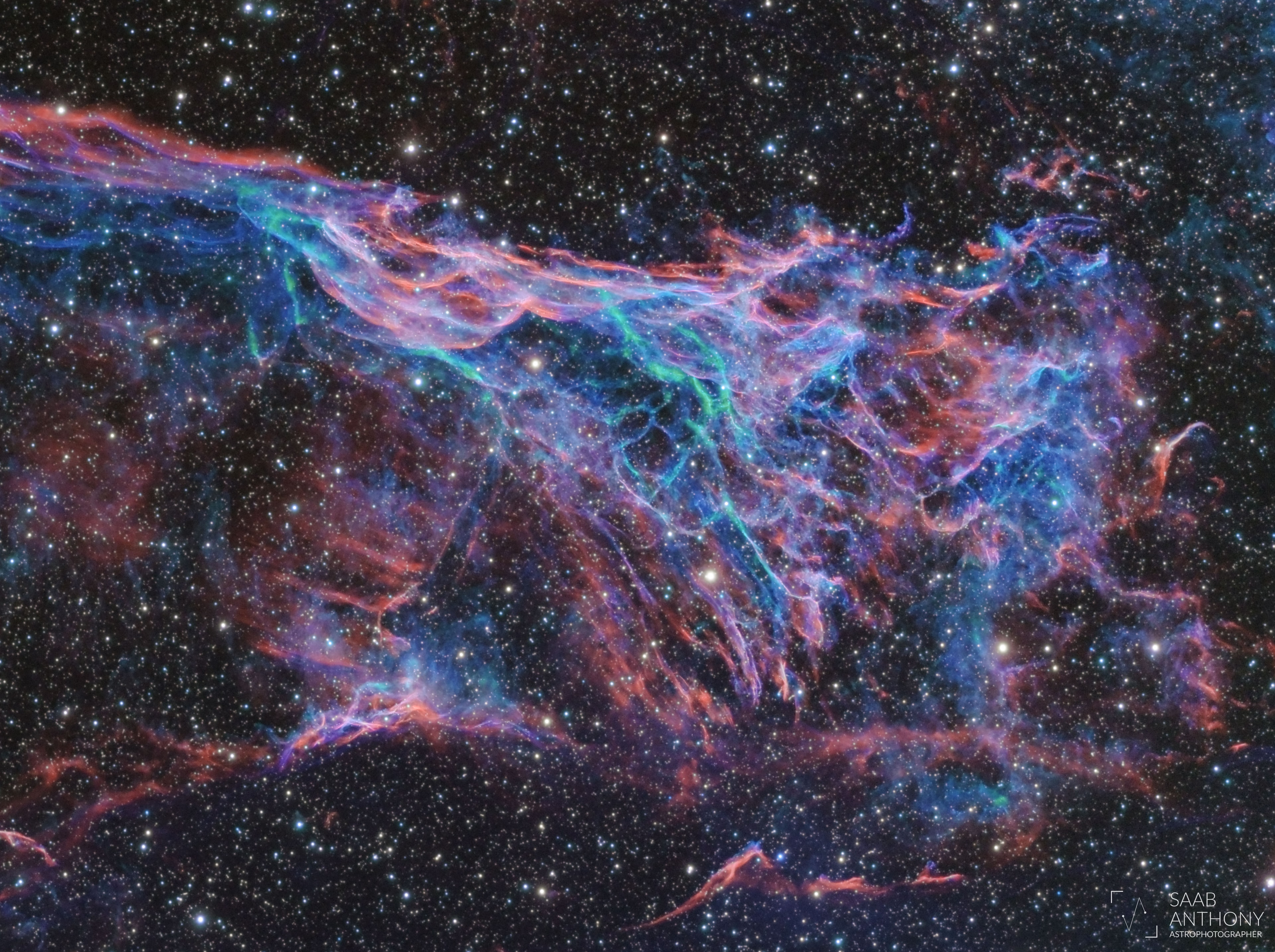 Chaotic in appearance, these tangled filaments of shocked, glowing gas are spread across planet Earth's sky toward the constellation of Cygnus as part of the Veil Nebula. The Veil Nebula itself is a large supernova remnant, an expanding cloud born of the death explosion of a massive star. Light from the original supernova explosion likely reached Earth over 5,000 years ago. The glowing filaments are really more like long ripples in a sheet seen almost edge on, remarkably well separated into the glow of ionized hydrogen atoms shown in blue and oxygen in red hues. Also known as the Cygnus Loop and cataloged as NGC 6979, the Veil Nebula now spans about 6 times the diameter of the full Moon. The length of the wisp corresponds to about 30 light years, given its estimated distance of 2,400 light years.  Often identified as Pickering's Triangle for a director of Harvard College Observatory, it is also named for its discoverer, astronomer Williamina Fleming, as Fleming's Triangular Wisp.