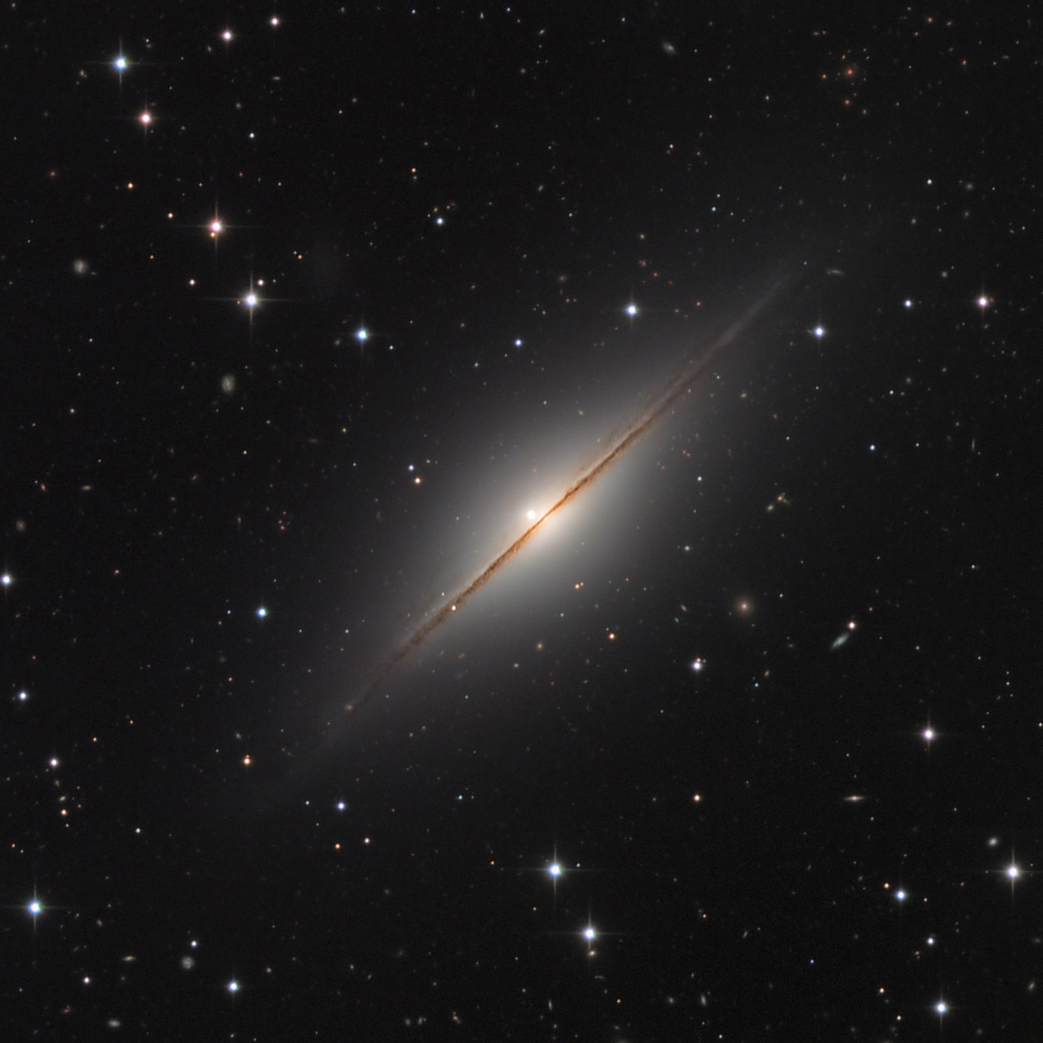Point your telescope toward the high flying constellation Pegasus and you can find this expanse of Milky Way stars and distant galaxies. NGC 7814 is centered in the pretty field of view that would almost be covered by a full moon. NGC 7814 is sometimes called the Little Sombrero for its resemblance to the brighter more famous M104, the Sombrero Galaxy. Both Sombrero and Little Sombrero are spiral galaxies seen edge-on, and both have extensive halos and central bulges cut by a thin disk with thinner dust lanes in silhouette. In fact, NGC 7814 is some 40 million light-years away and an estimated 60,000 light-years across. That actually makes the Little Sombrero about the same physical size as its better known namesake, appearing smaller and fainter only because it is farther away. In this telescopic view from July 17, NGC 7814 is hosting a newly discovered supernova, dominant immediately to the left of the galaxy's core. Cataloged as SN 2021rhu, the stellar explosion has been identified as a Type Ia supernova, useful toward calibrating the distance scale of the universe.