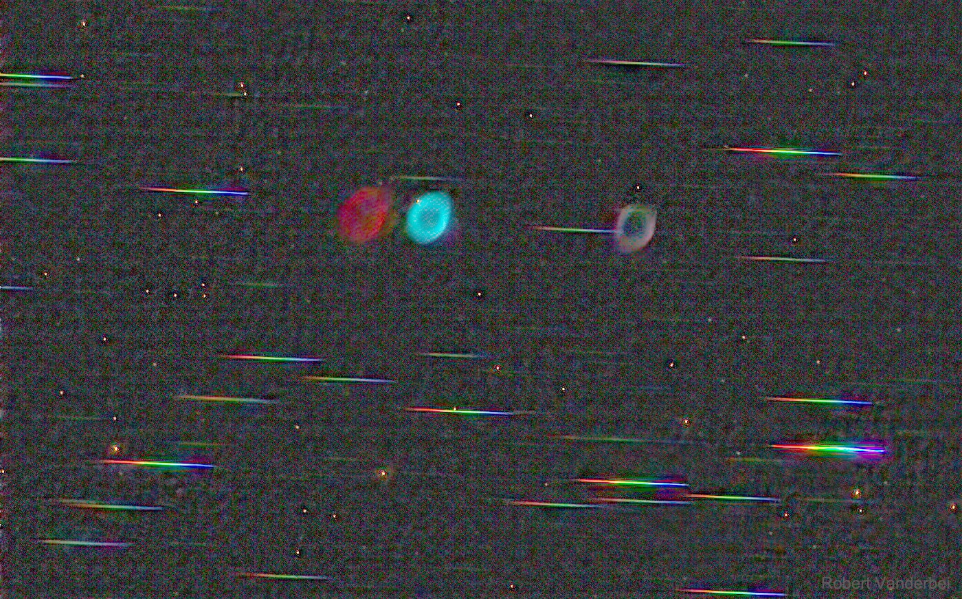 What if you could see, separately, all the colors of the Ring? And of the surrounding stars? There's technology for that. The featured image shows the Ring Nebula (M57) and nearby stars through such technology: in this case, a prism-like diffraction grating.  The Ring Nebula is seen only a few times because it emits light, primarily, in only a few colors. The two brightest emitted colors are hydrogen (red) and oxygen (blue), appearing as nearly overlapping images to the left of the image center.  The image just to the right of center is the color-combined icon normally seen.  Stars, on the other hand, emit most of their light in colors all across the visible spectrum.  These colors, combined, make a nearly continuous streak -- which is why stars appear accompanied by multicolored bars.  Breaking object light up into colors is scientifically useful because it can reveal the elements that compose that object, how fast that object is moving, and how distant that object is.